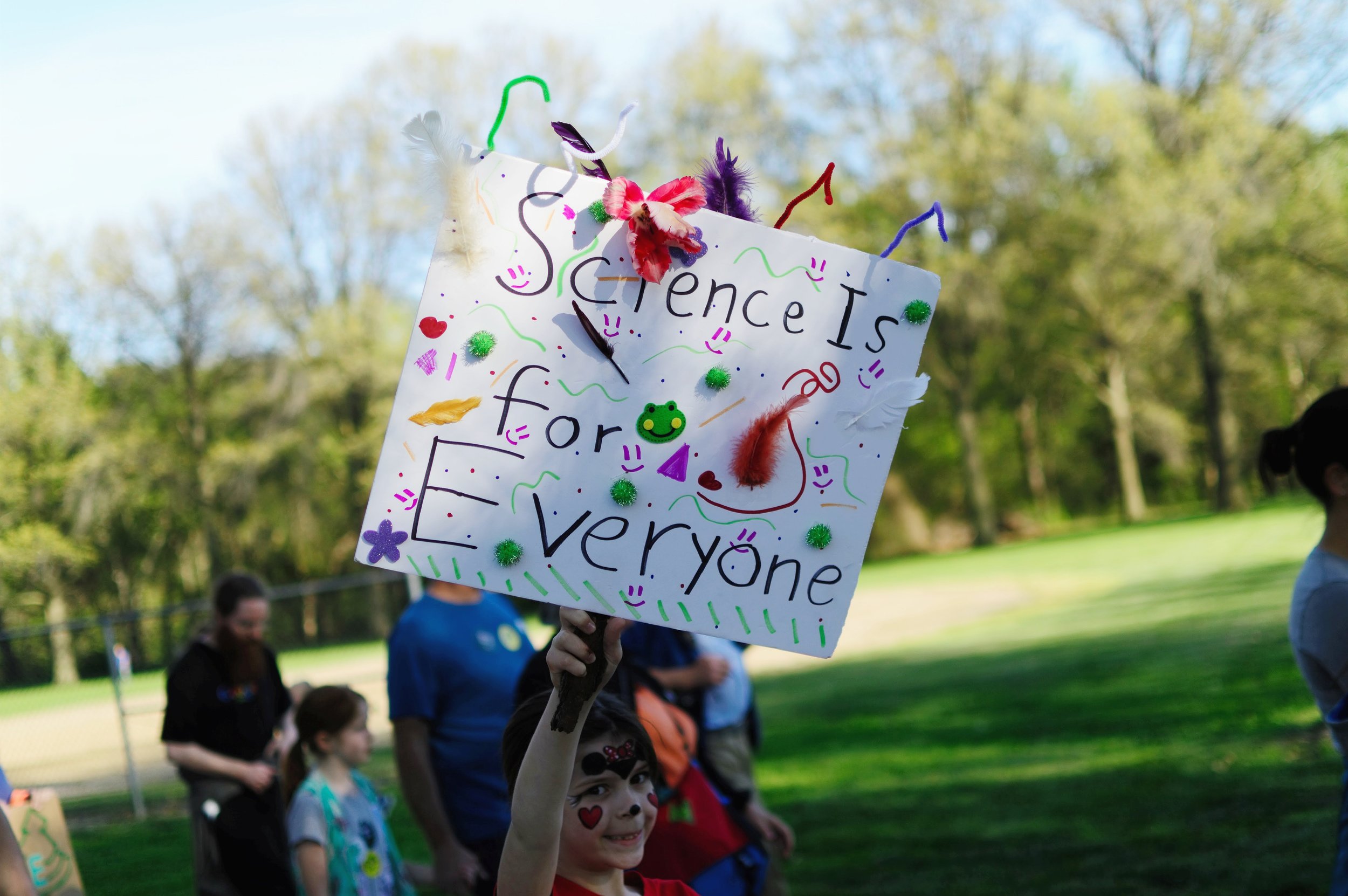 A young girl holds a sign that says "Science is for Everyone" at the March for Science in Omaha, Nebraska, in 2017.