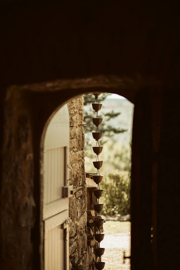 Stone archway and timber doorway inside Casa Santiago at L'Esprit d'Almières