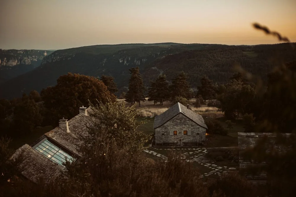 Evening light across L'Esprit d'Almières, the restored stone estate in Aveyron hosting Casa Retreats France