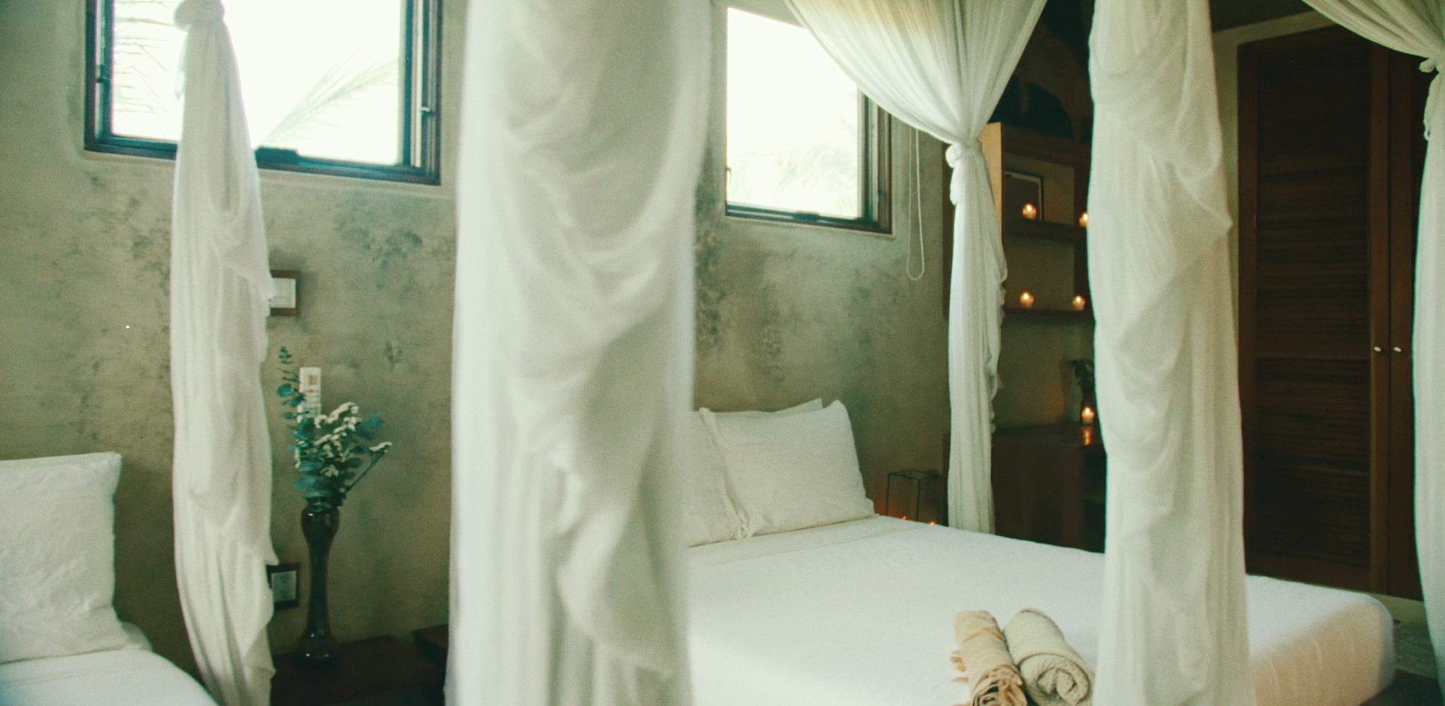 Canopy bed detail and natural textures inside Casa Maya Ka’an — Sian Ka’an luxury yoga retreat stay