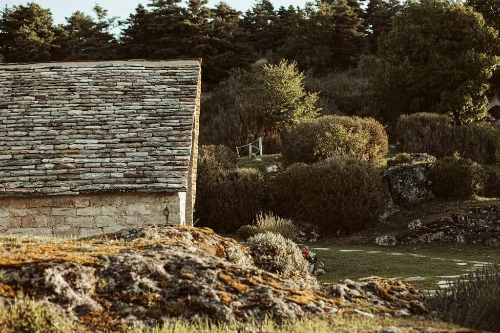 Historic stone farmhouse and surrounding landscape at L'Esprit d'Almières in the Aveyron, Southern France