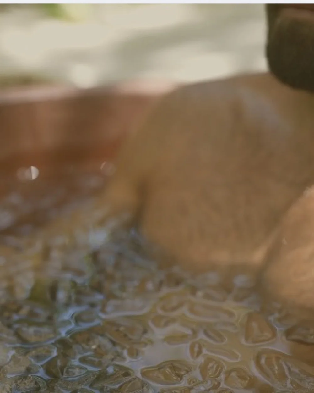 Close-up of a guest immersed in an outdoor ice bath at Amaria in Portugal