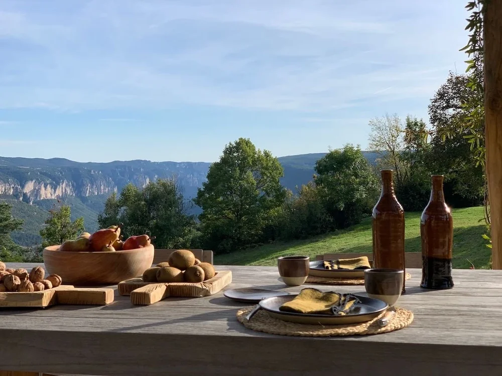 Seasonal private-chef dining overlooking the Aveyron landscape at Casa Retreats France