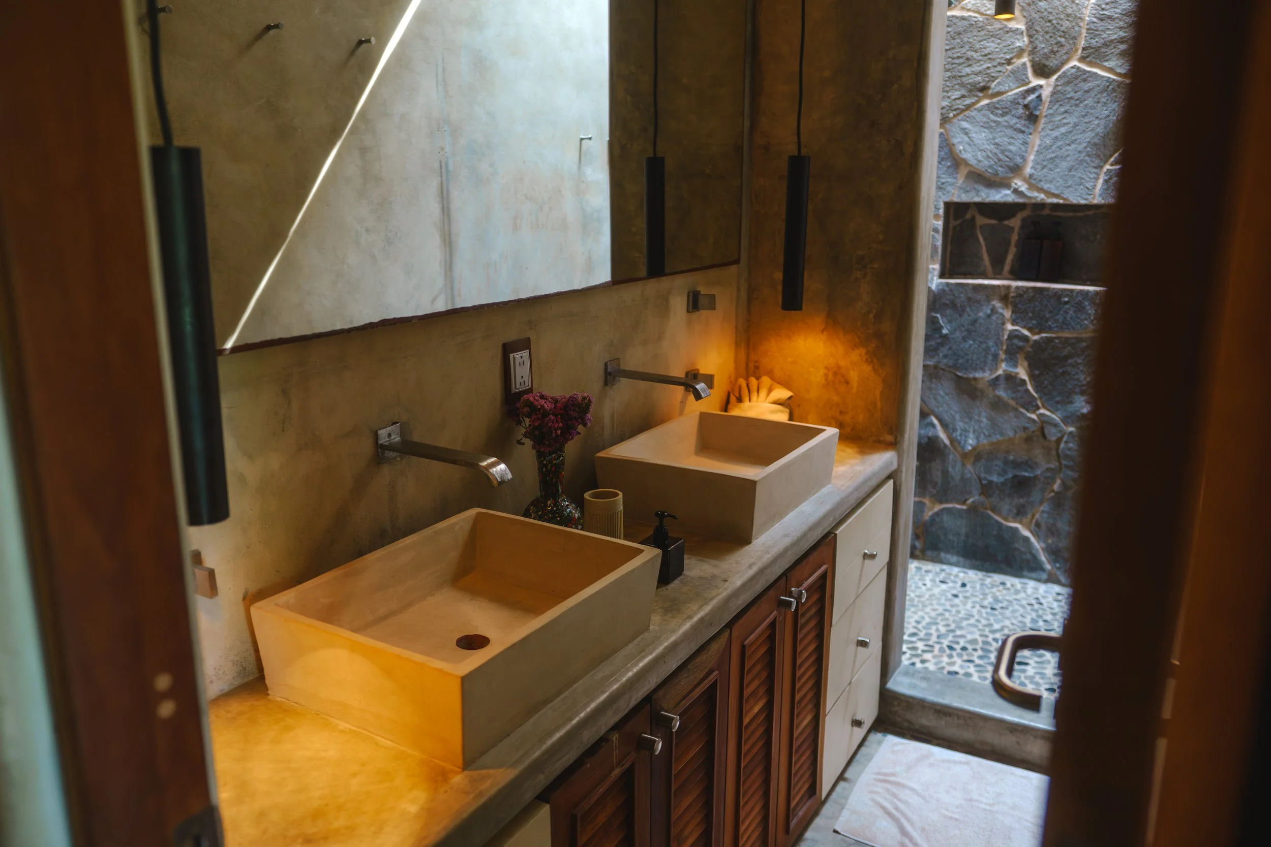 Ensuite bathroom with rain shower and double vanity — elevated comfort for a luxury wellness retreat in Mexico
