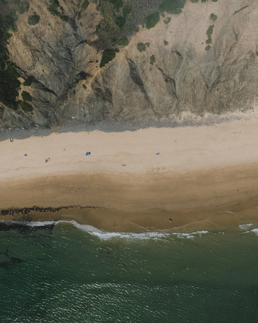Aerial view of a sheltered Atlantic beach below the cliffs of Portugal’s Costa Vicentina, near Amaria