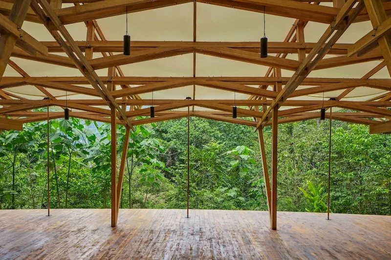 Open-air jungle shala set for two daily yoga classes.
