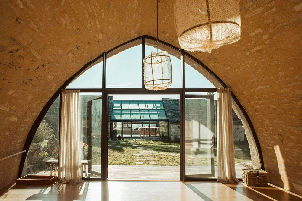 Restored stone yoga studio at L'Esprit d'Almières opening onto the surrounding landscape