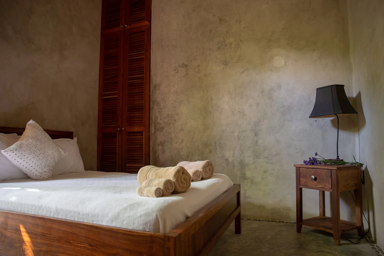 Ground-level garden bedroom with independent entrance—cool, quiet lodging at Casa Maya Ka’an for yoga retreat guests in Tulum.