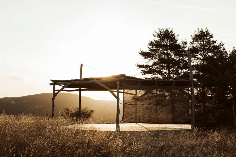 Outdoor yoga platform in an open meadow at L'Esprit d'Almières in the Causses and Cévennes