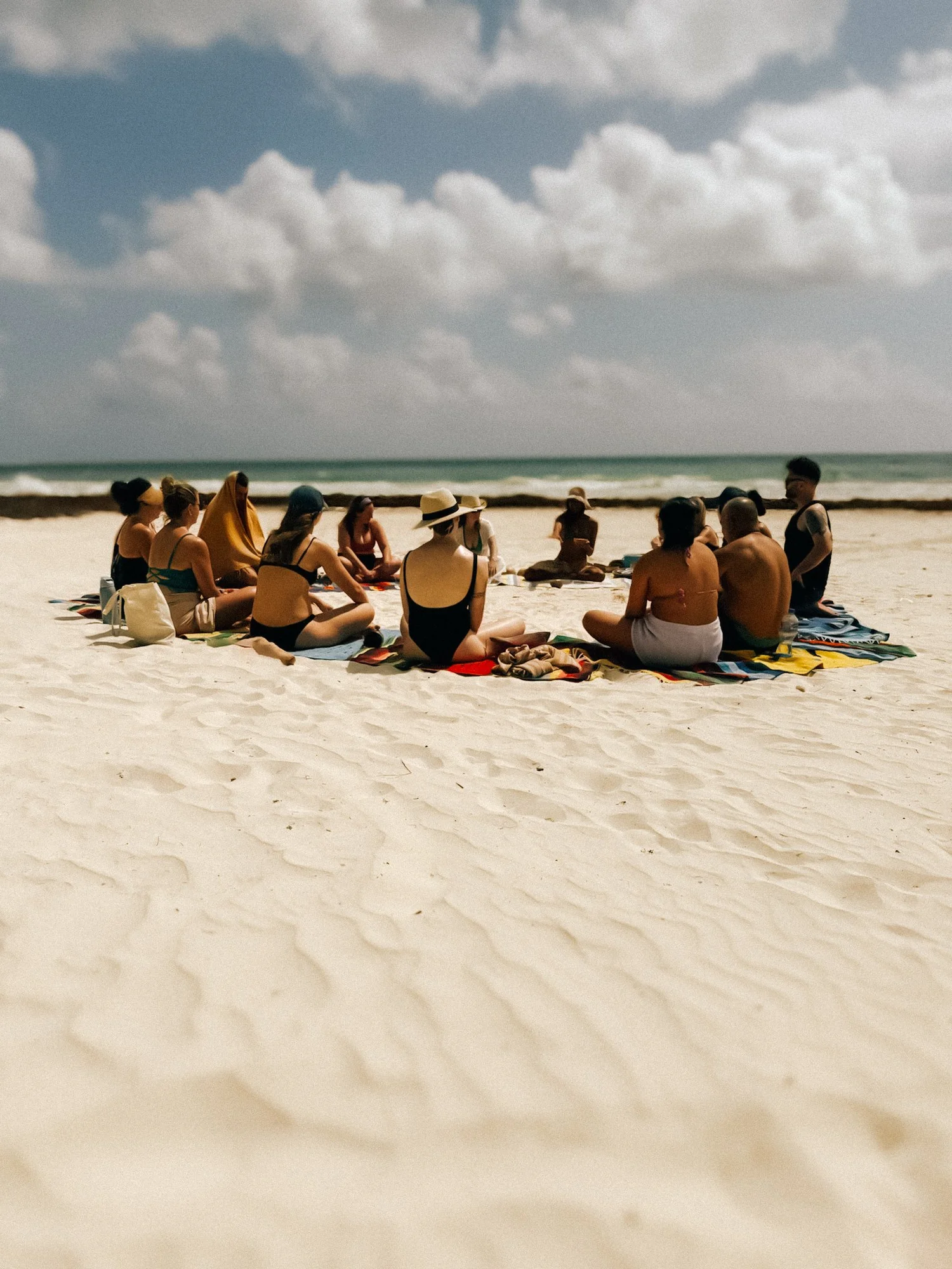 Mayan clay ritual at the shoreline—mineral-rich clay with sea rinse for renewal.