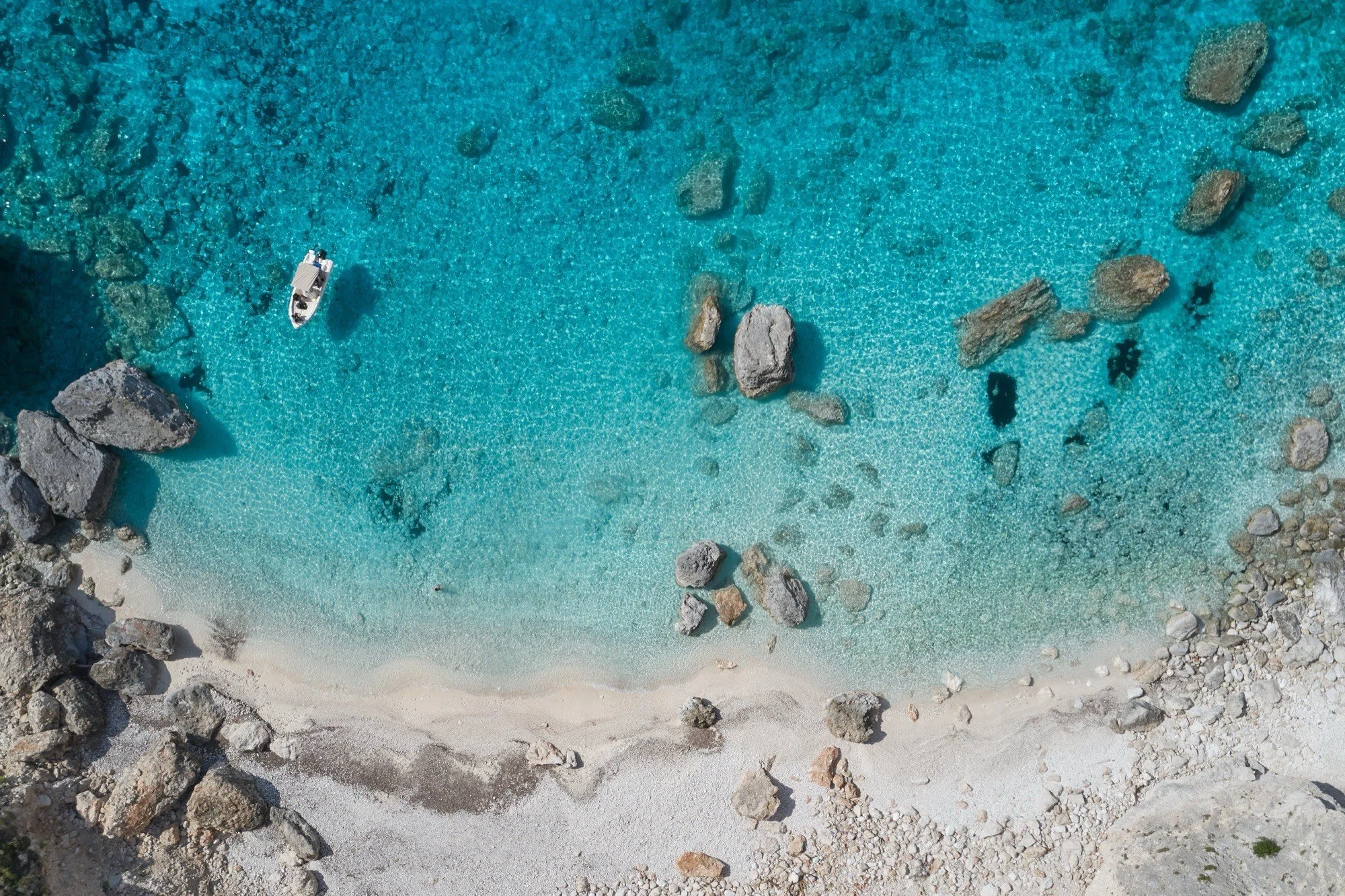 Aerial view of a turquoise cove on Zakynthos in the Ionian Sea, Greece, where Casa Retreats hosts its retreat from August 29 to September 4, 2027 in collaboration with Nomadikas