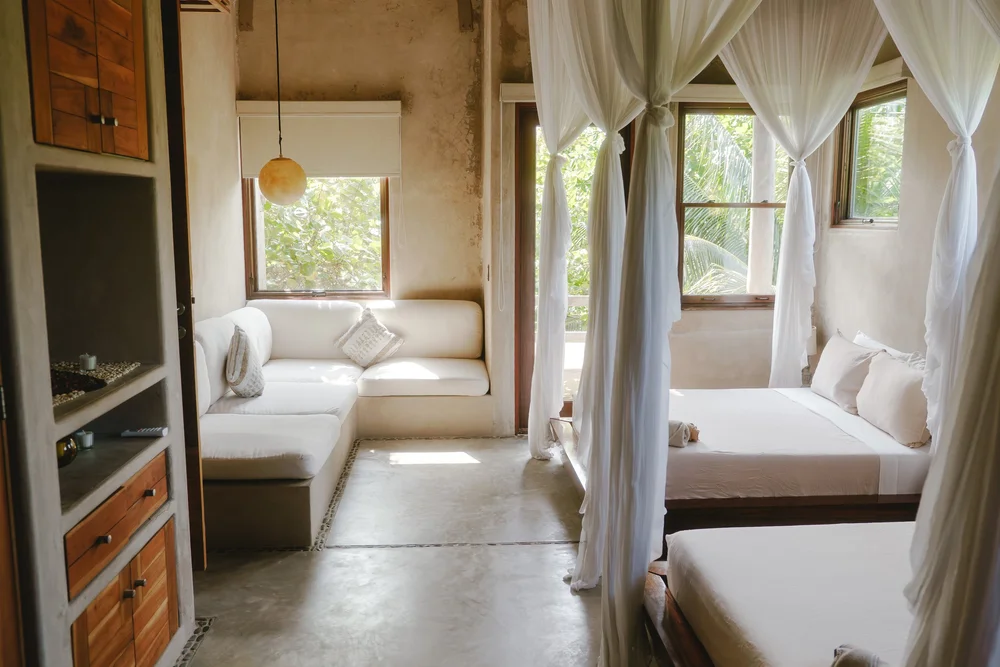 Double Queen Canopy Suite at Casa Retreats—private terrace and canopy beds designed for a luxury yoga & wellness retreat in Tulum, Mexico.