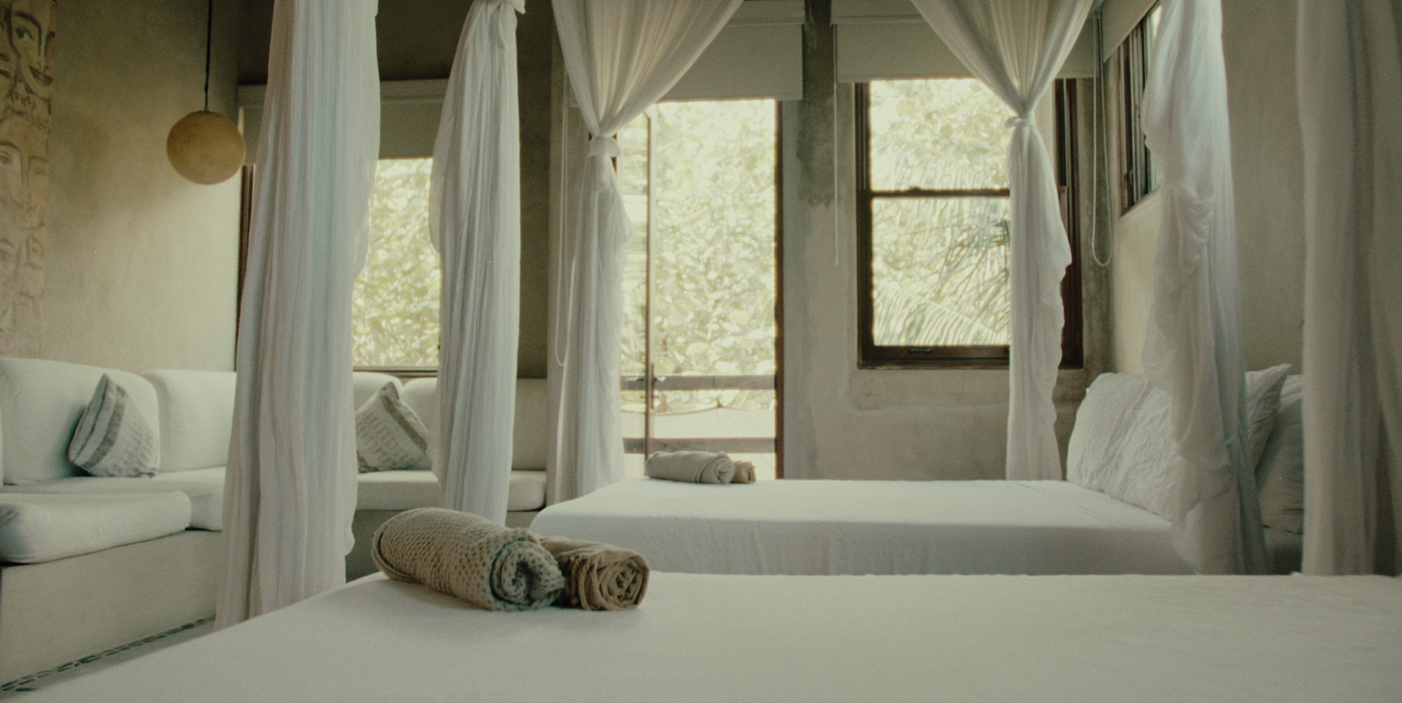 Serene jungle-view suite with dual-vanity ensuite—Casa Retreats accommodations for travelers seeking elevated comfort during a Tulum yoga retreat.