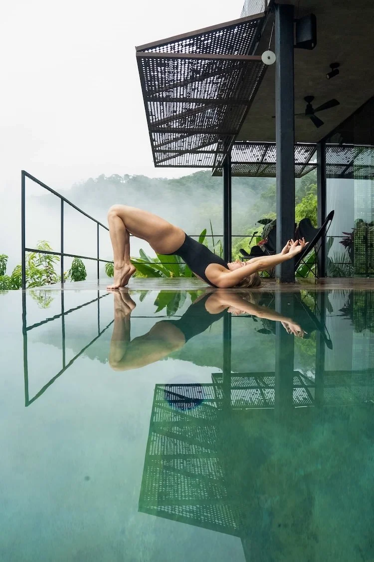 Poolside practice space with teak decking and tropical views—calm, spacious, and bright.