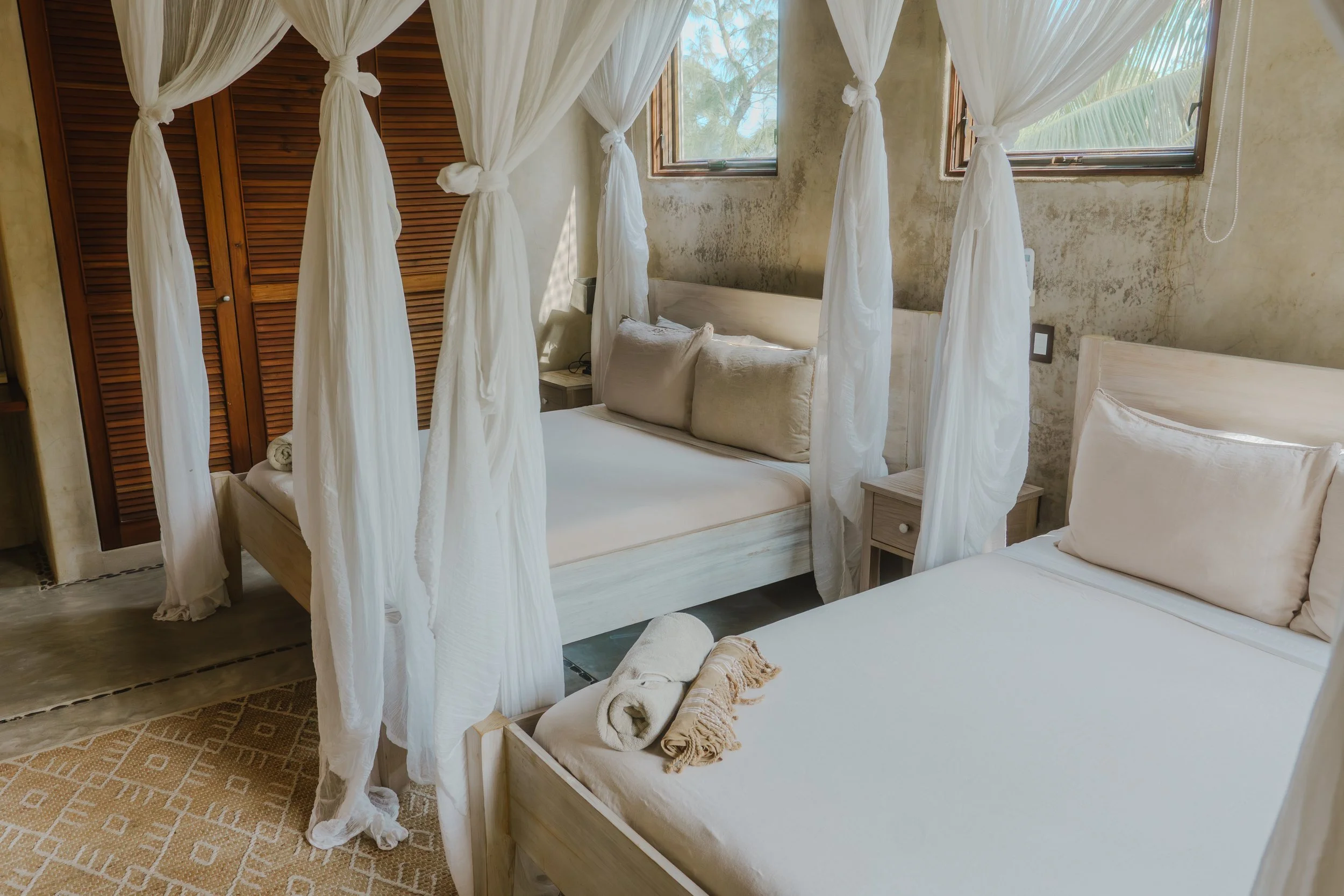 Luxury wellness retreat accommodations in Sian Ka’an, Mexico — double queen canopy suite at Casa Maya Ka’an near Tulum