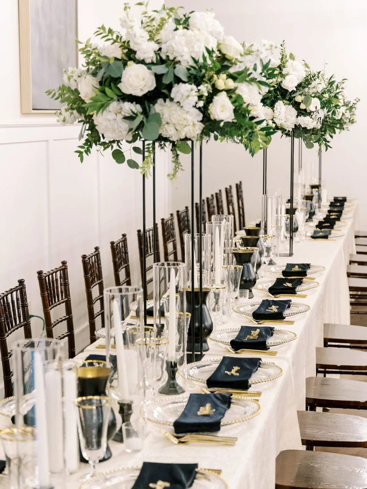 Elegant, timeless, and full of contrast!

This head table was a dream &mdash; lush white and green florals paired with black velvet napkins for a look that&rsquo;s both classic and modern. The textures, the tones, and the little details came together