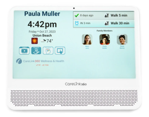 Digital wellness device screen displaying name Paula Muller, current time 4:42 pm, date October 27, 2023, location Union Beach, weather 74°F, family members' photos, upcoming walk reminders, wellness app icons, and CareLink360 branding.