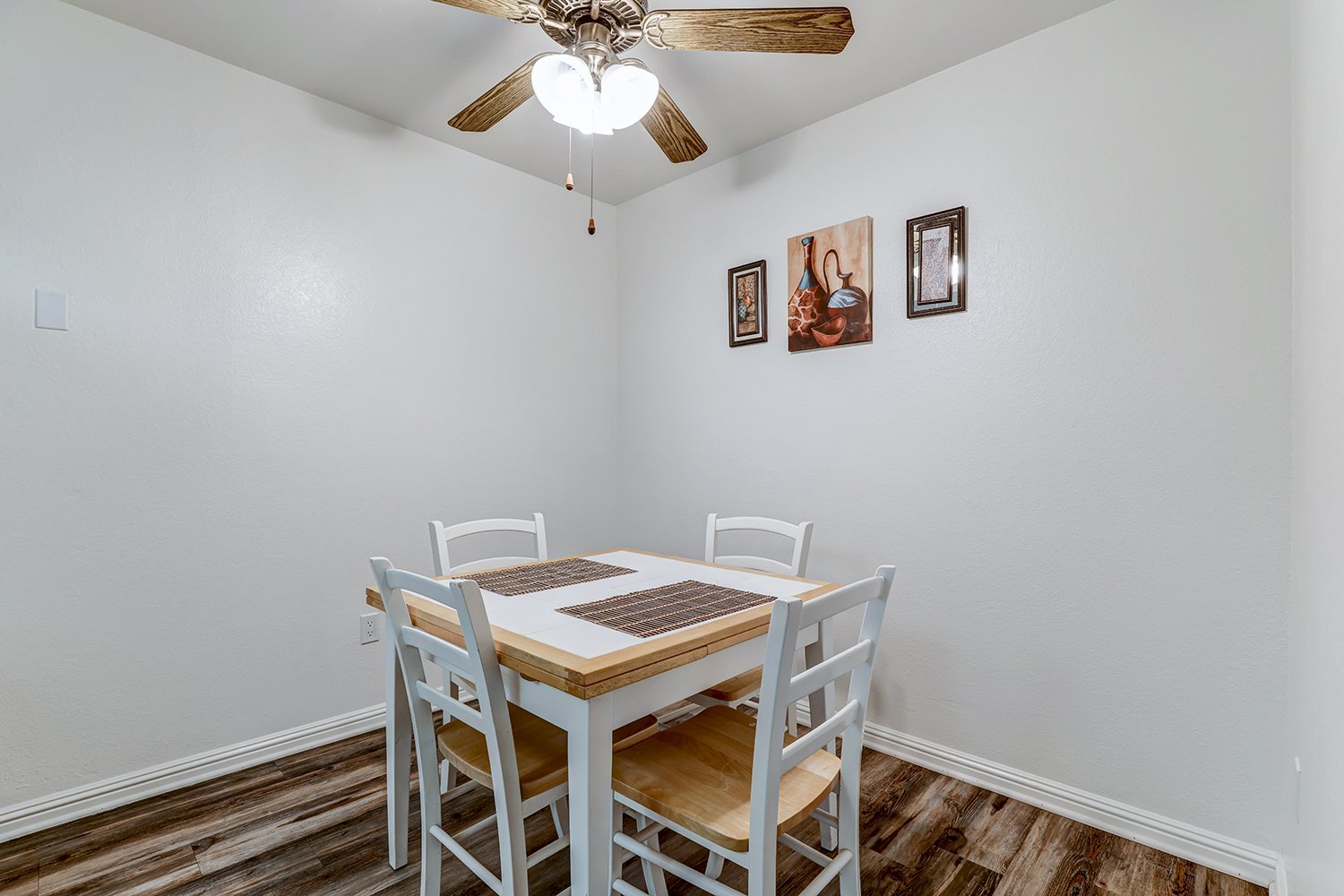 This image showcases the dining room with a dining room table seating four.