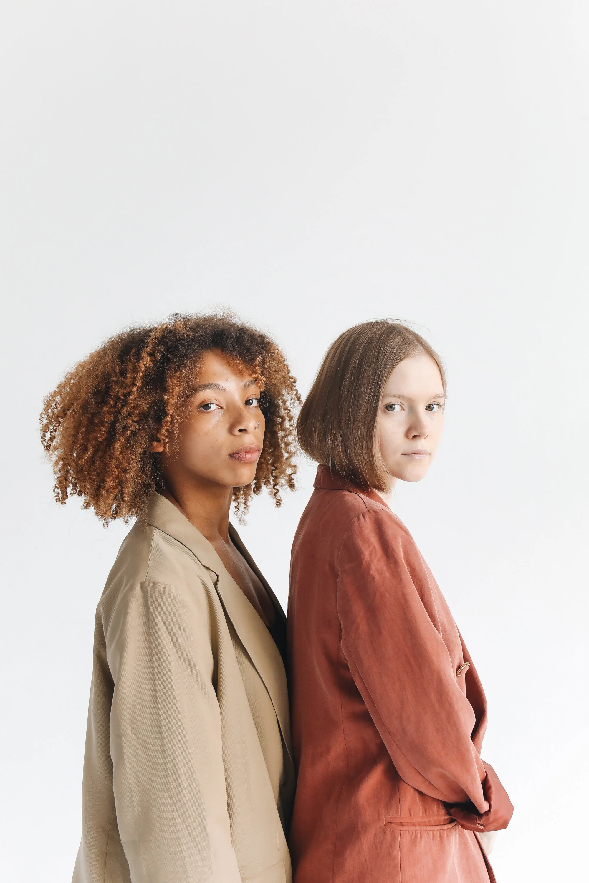 woman-in-brown-coat-standing-beside-woman-in-brown-coat-4820224.jpg