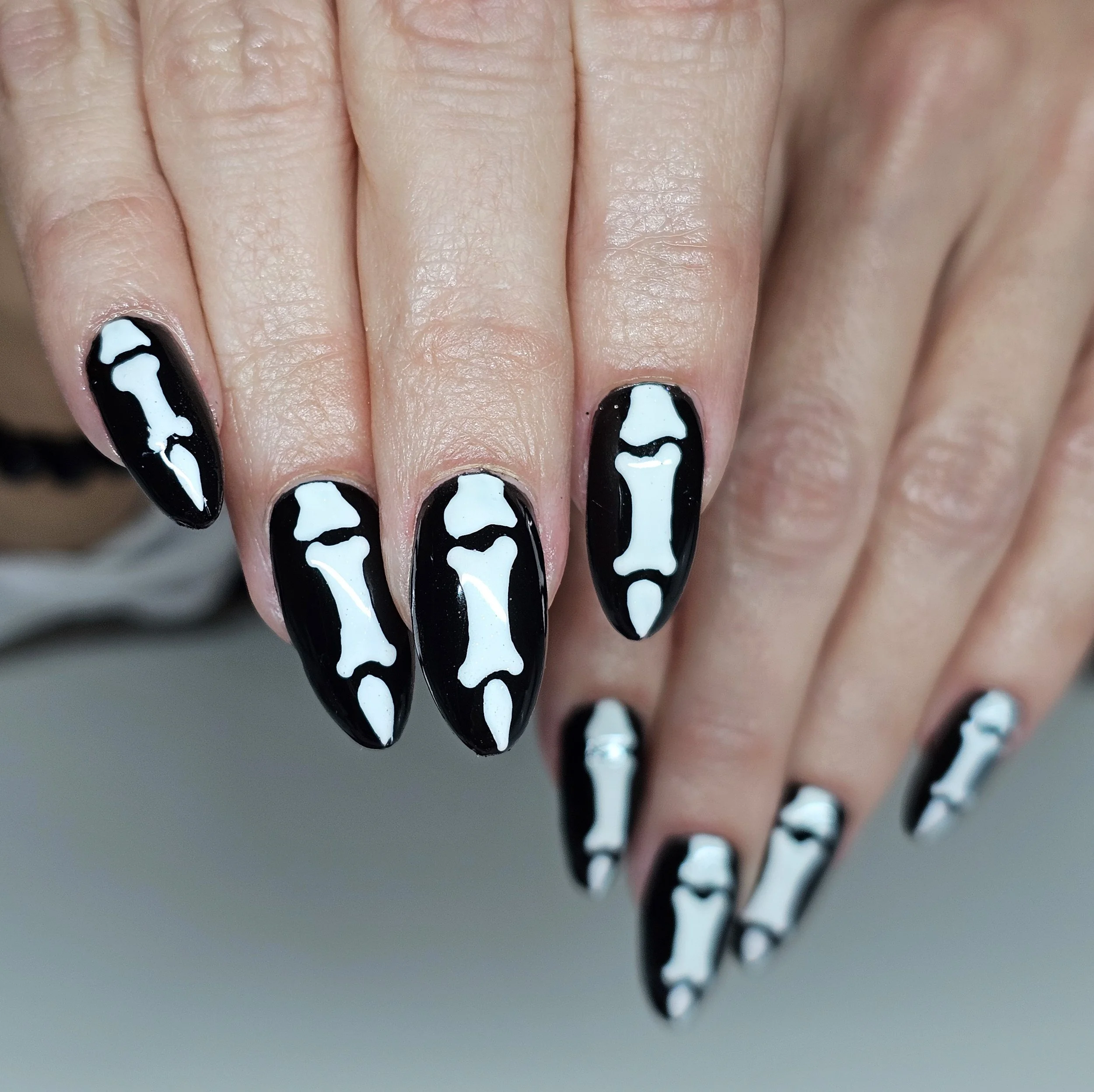 Boney finger against black which glow in the dark
