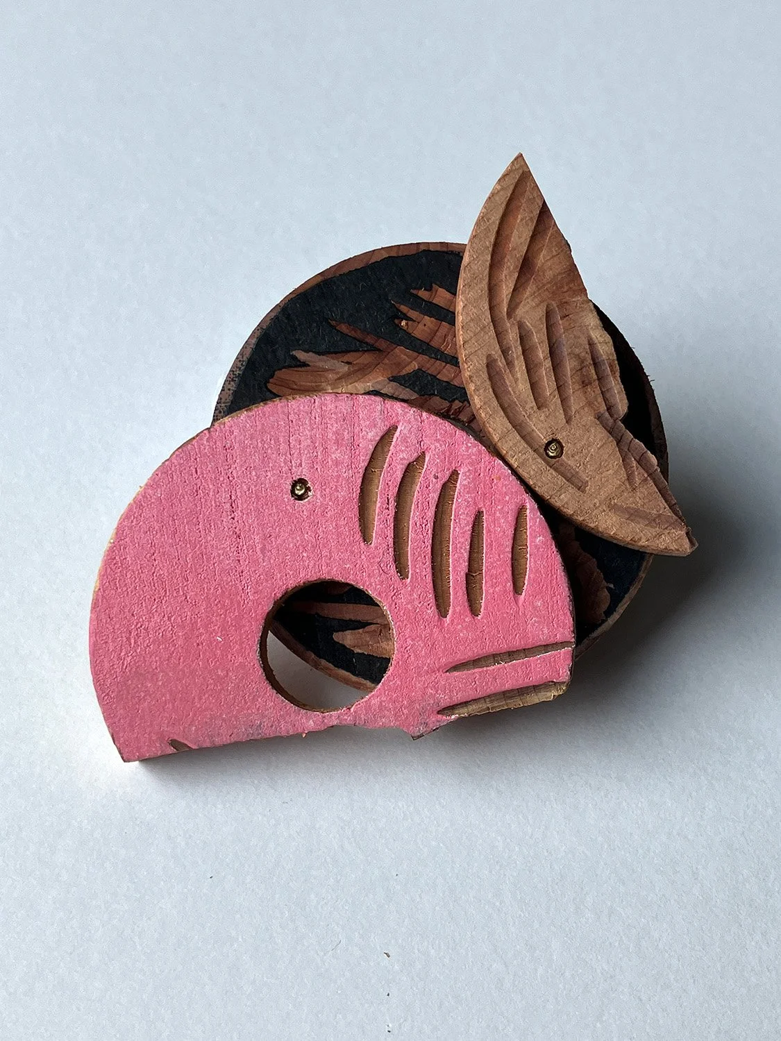 Challenge accepted, 2023, brooch with movable components/ carved cedar wood, oil-based ink, metal, 5.5cm x 6cm x 2cm©