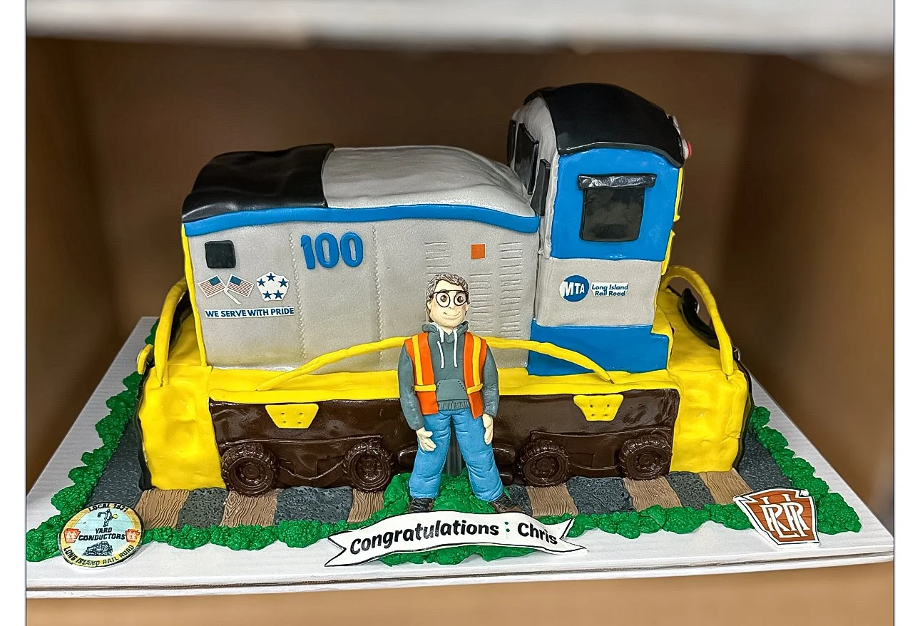 Custom Long Island Rail Road retirement cake featuring detailed train decorations and themed design elements