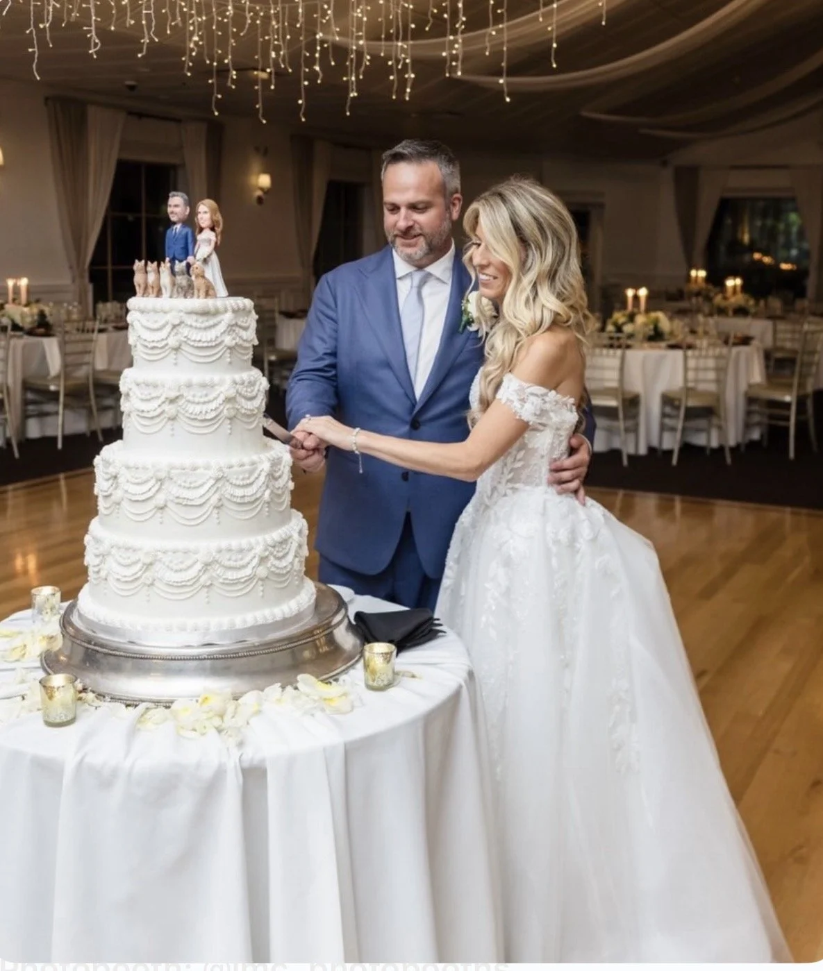 Four-tier vegan wedding cake with couple cutting their vintage style cake by veg on Board for a wedding at Flowerfield celebrations in St James, NY