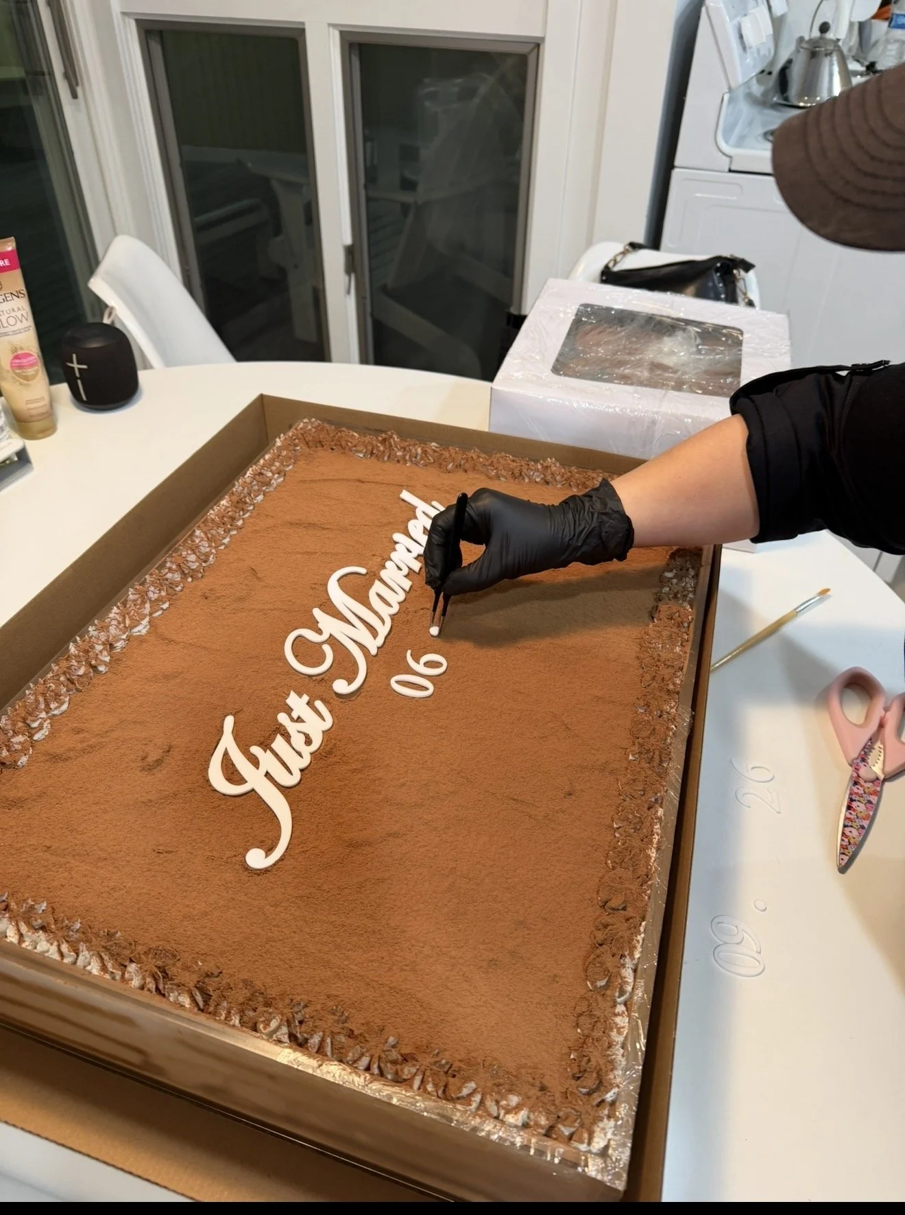 Placing acrylic letters on vegan tiramisu wedding cake