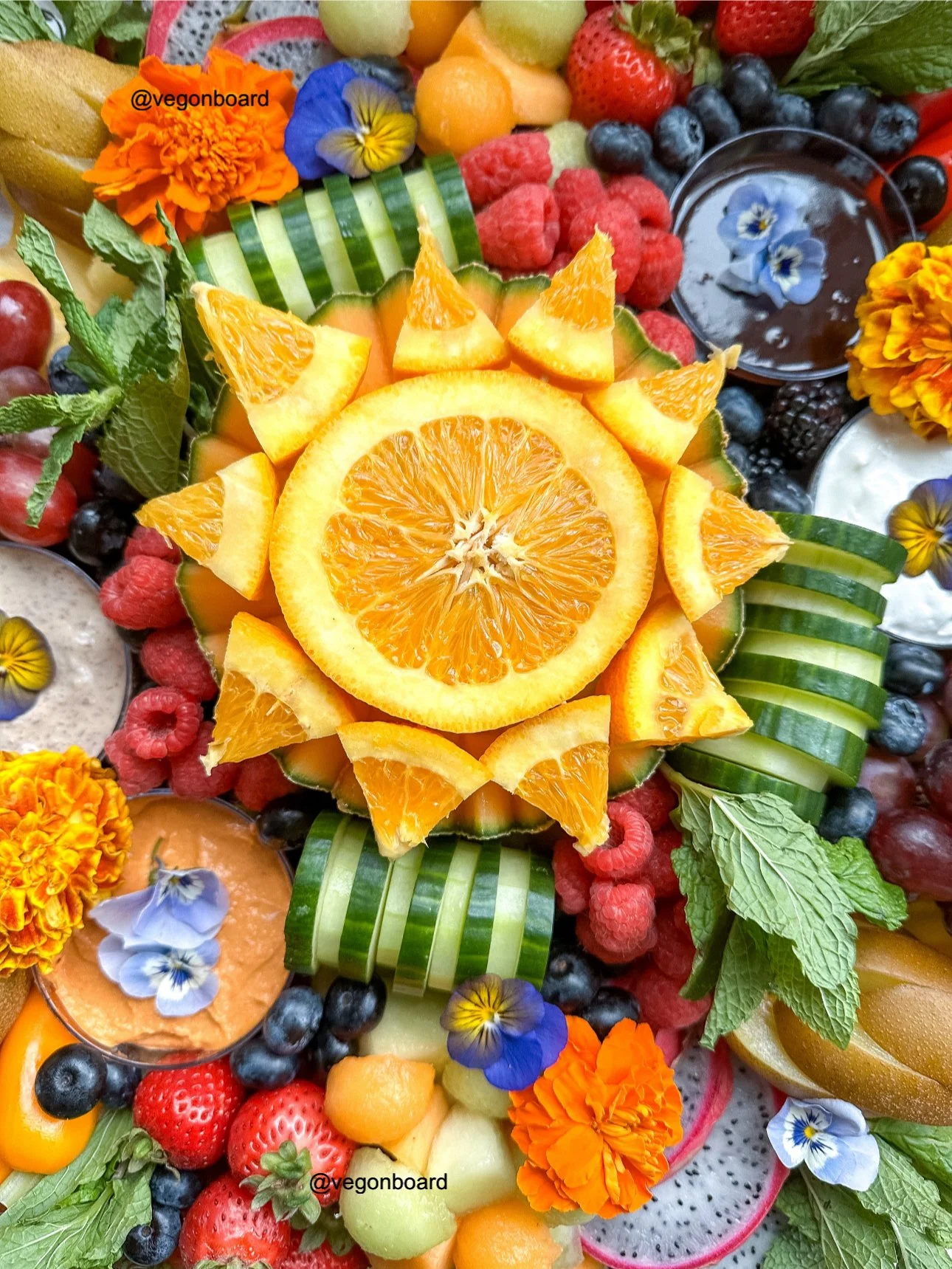 fruit board with sun shaped oranges veg on board