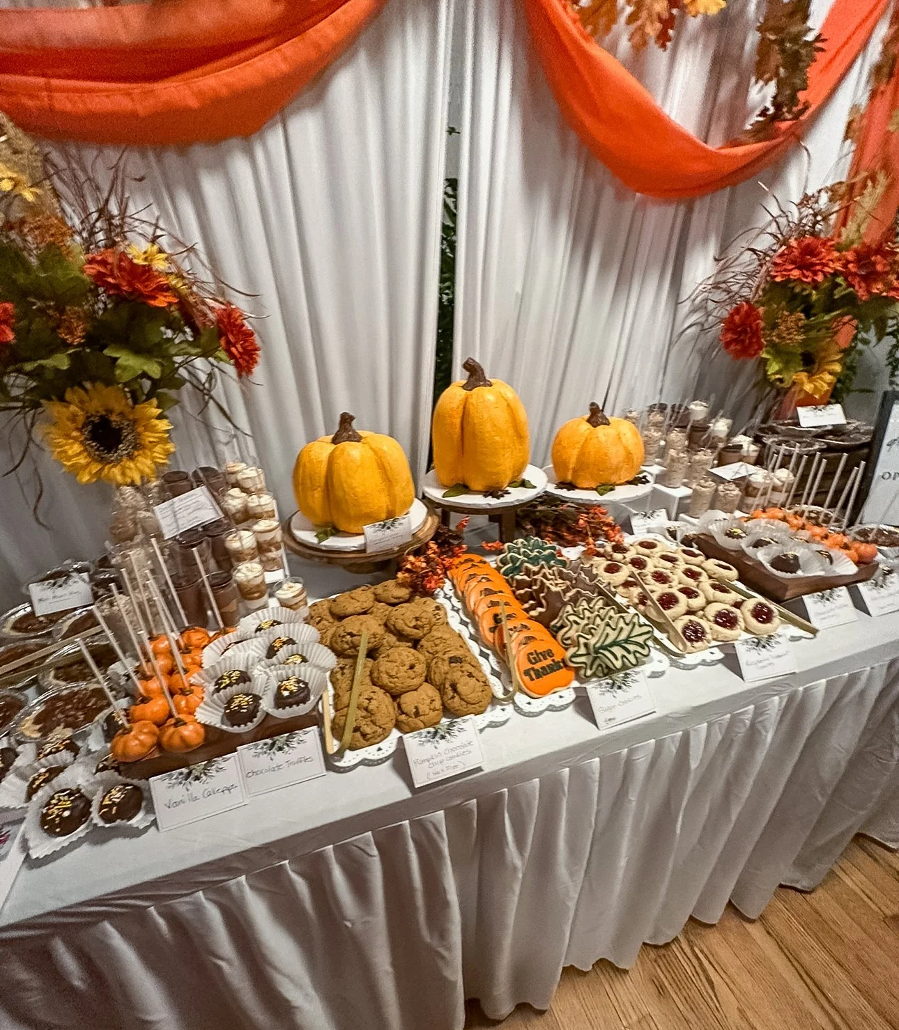 vegan Thanksgiving theme dessert table with pumpkin shaped cakes