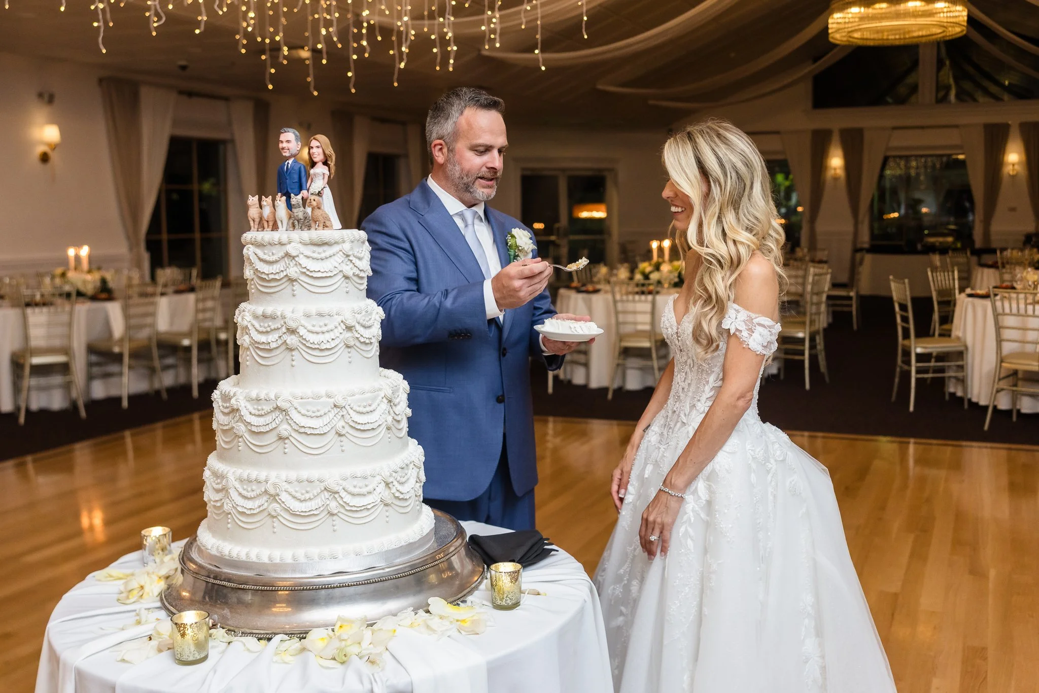 Couple tasting four tier vegan wedding cake made by Veg on Board on their wedding day at Flowerfield Celebrations in St James photo taken by Heritage House Photo