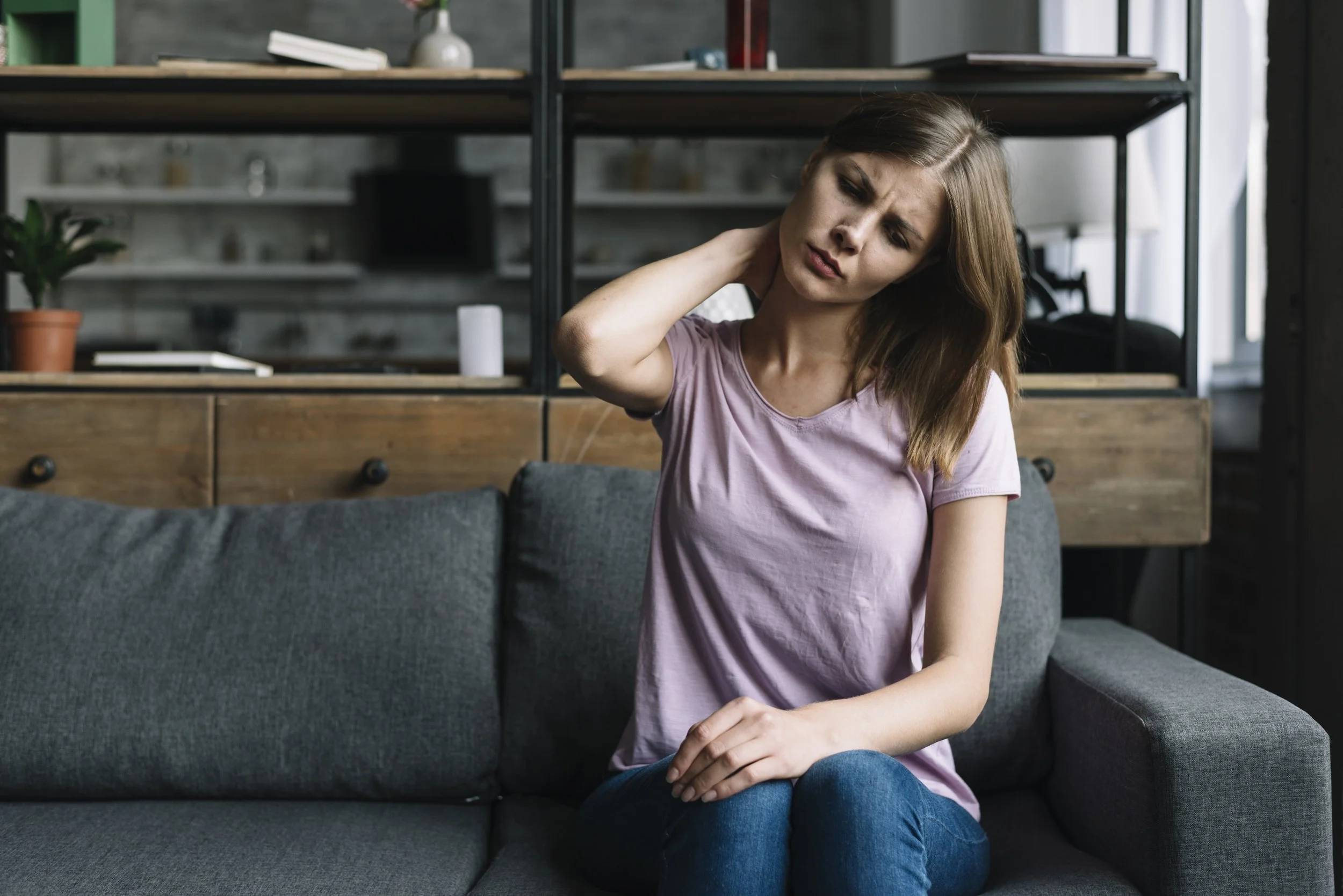 woman-sitting-sofa-suffering-from-neck-pain.jpg