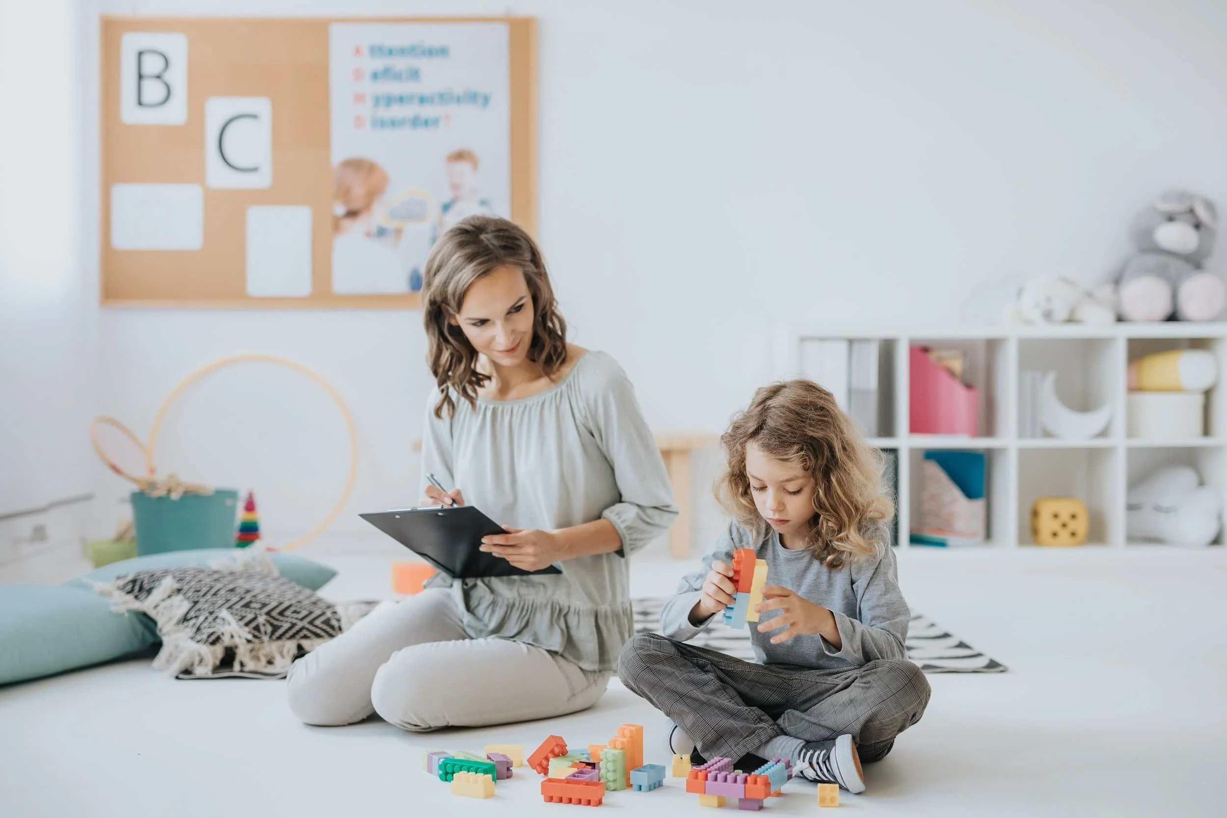 Therapist supporting child during initial evaluation after diagnosis