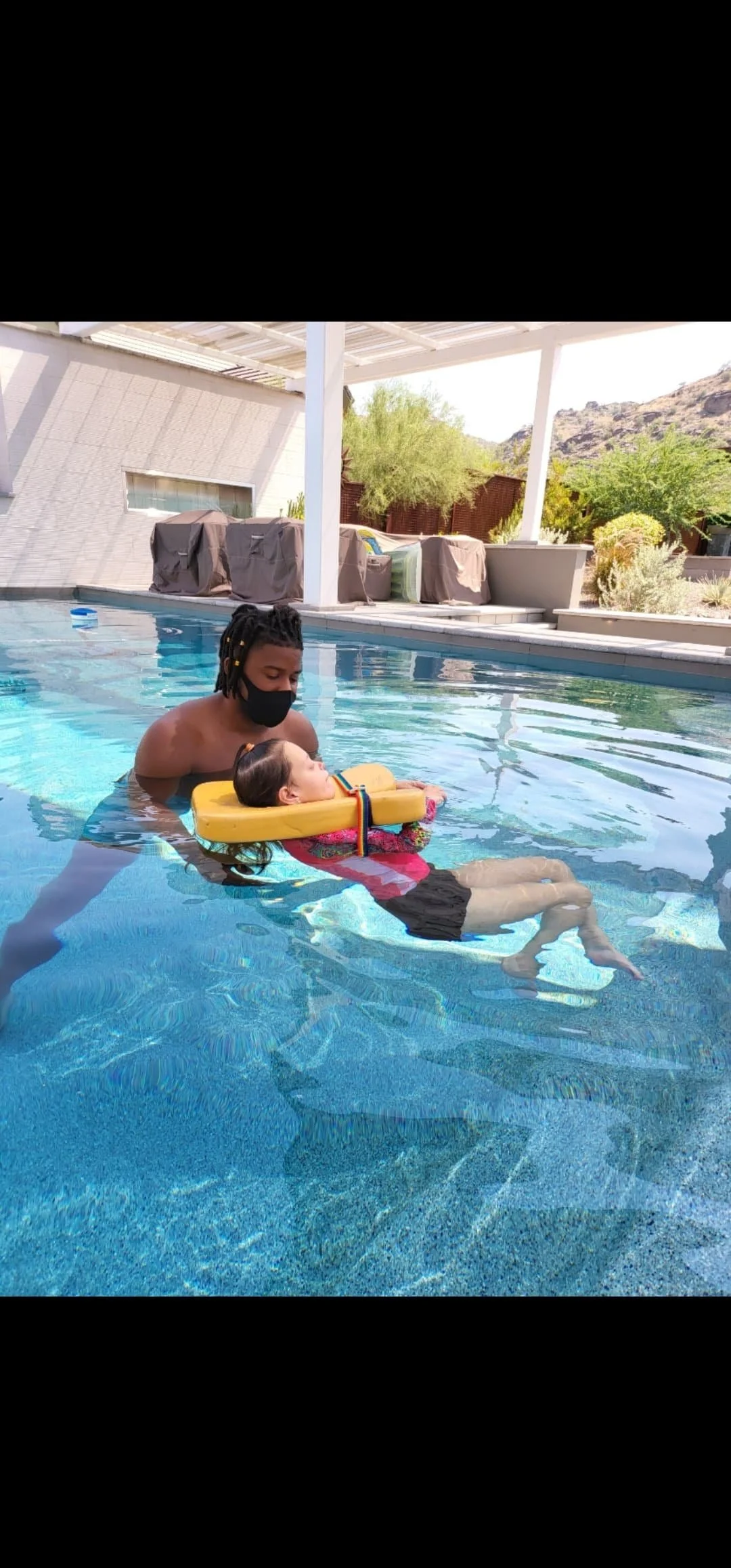 Aquatic therapy session—therapist supports child in a pool to improve motor skills, sensory integration, and confidence in a calming water environment