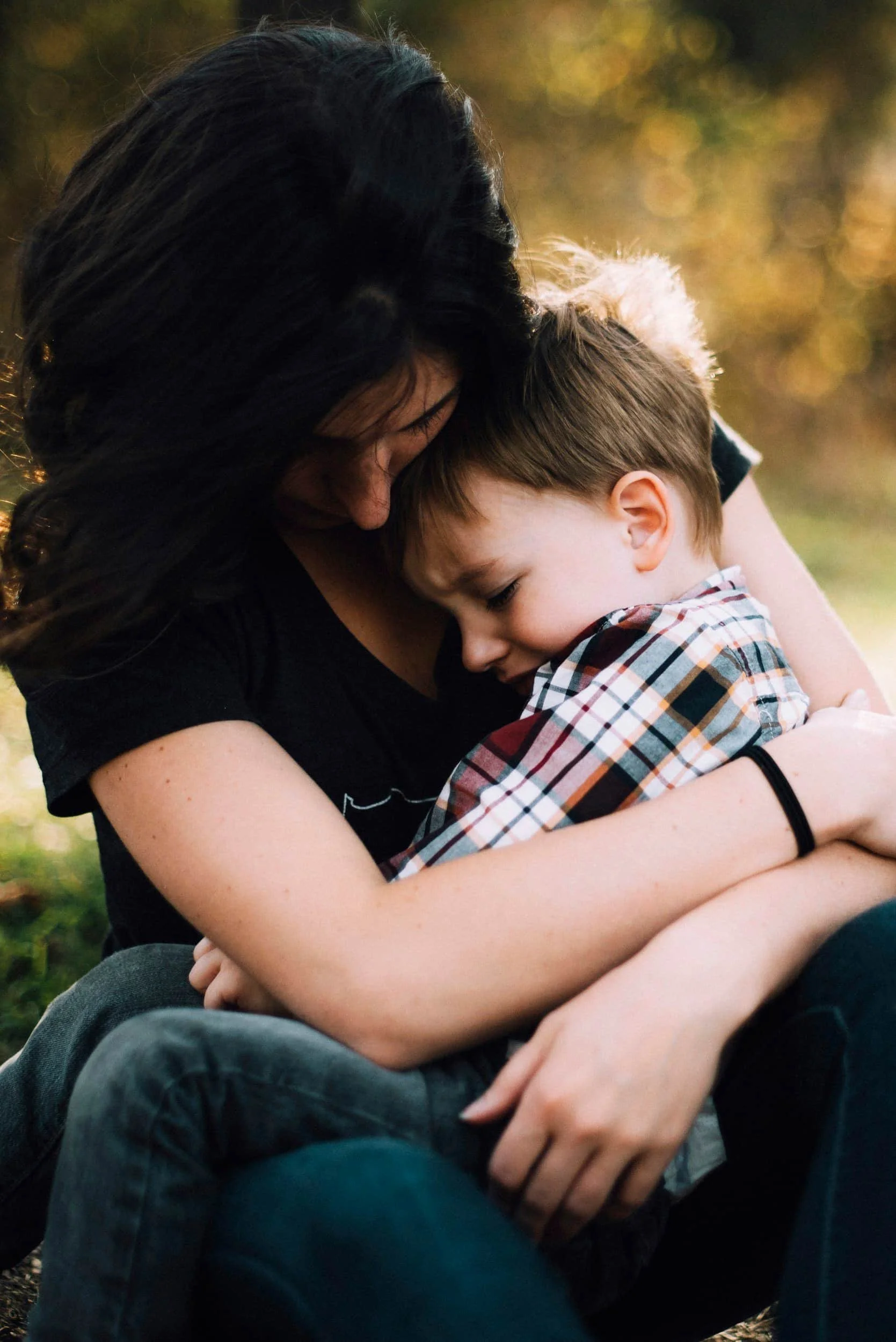 Parent comforting child during sensory overwhelm as part of neurodiversity-affirming support