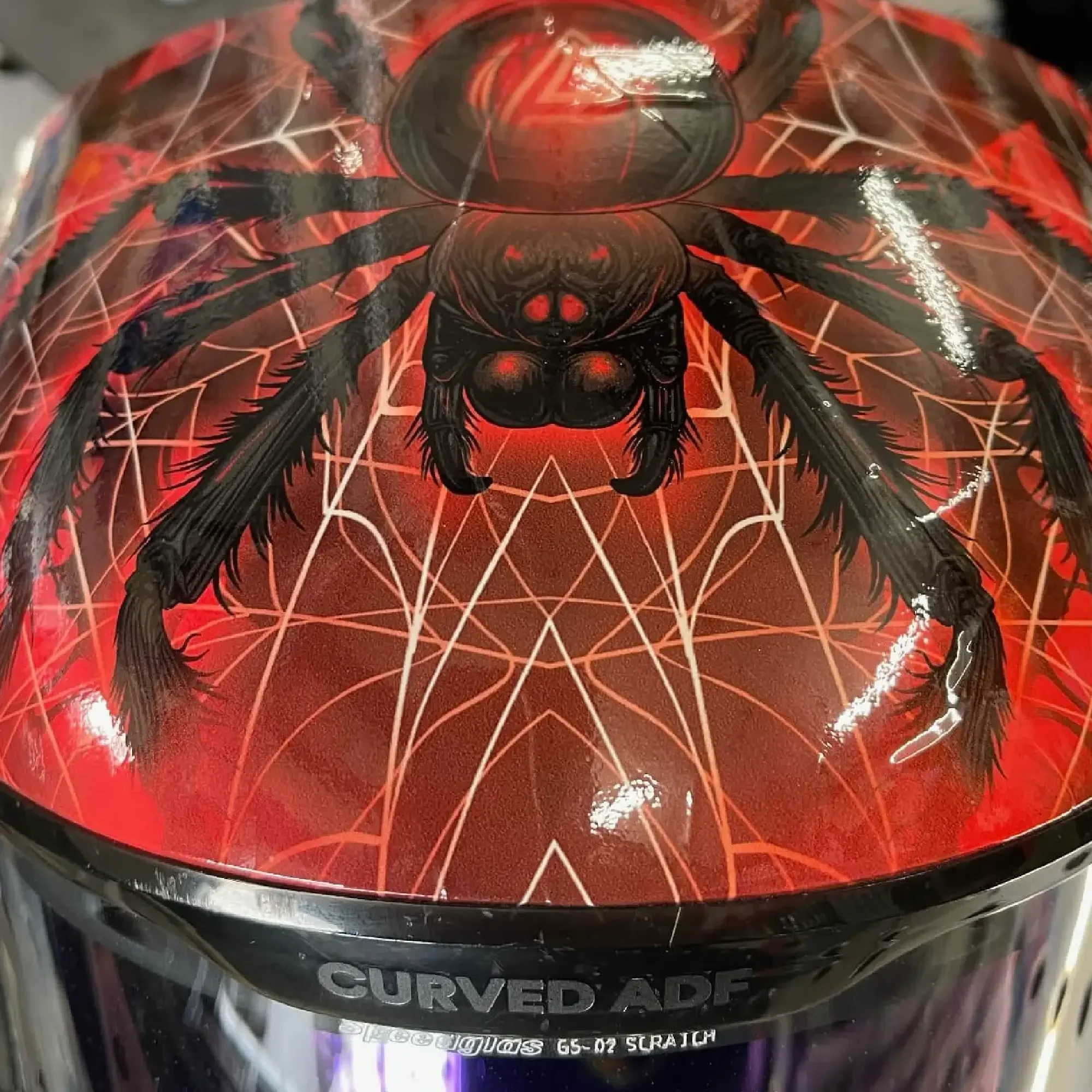 Spider G5-02 Welding Mask Shell Wrap – top detail featuring large black spider and red web pattern