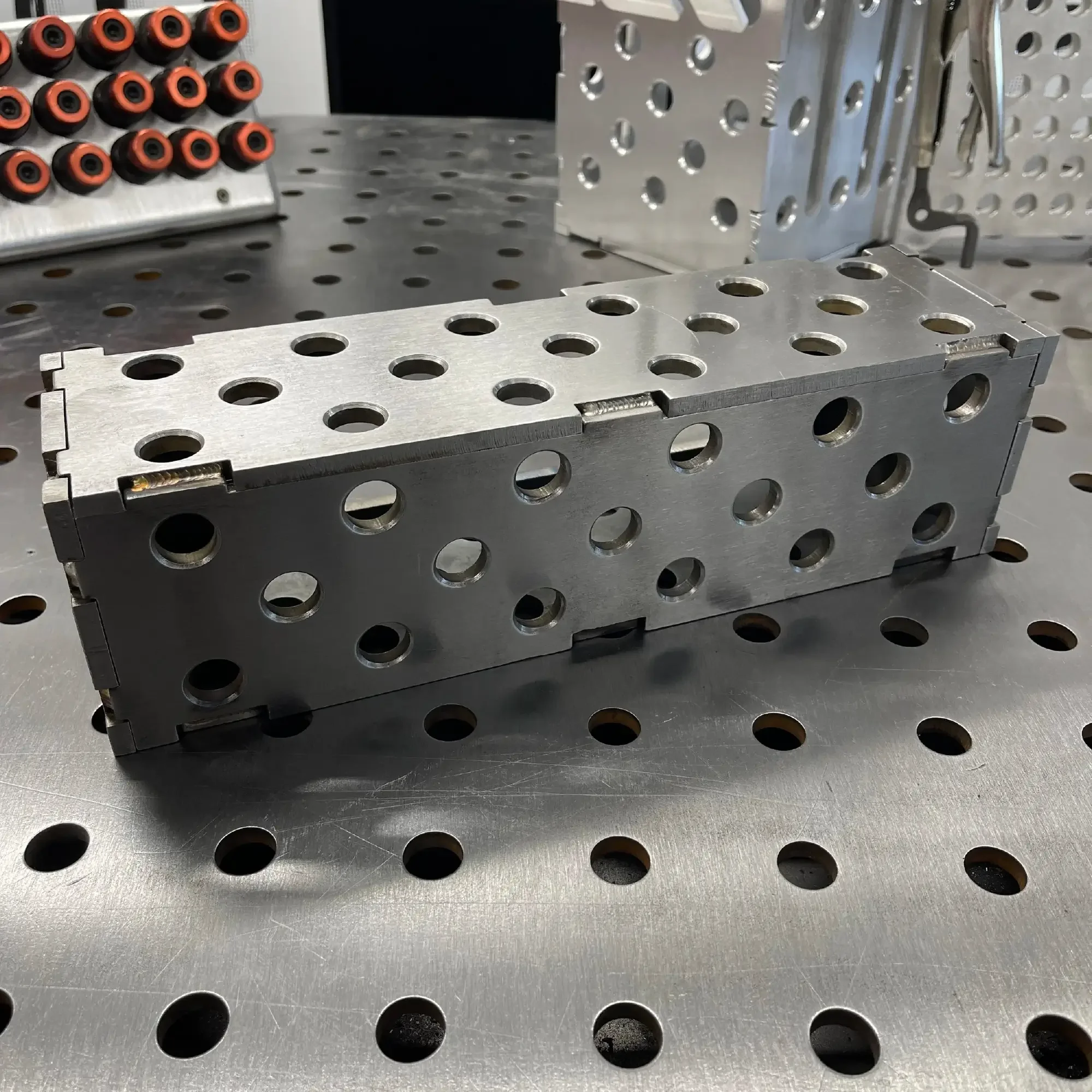 Steel Slim Riser Block – horizontal position on table showing brushed steel surface