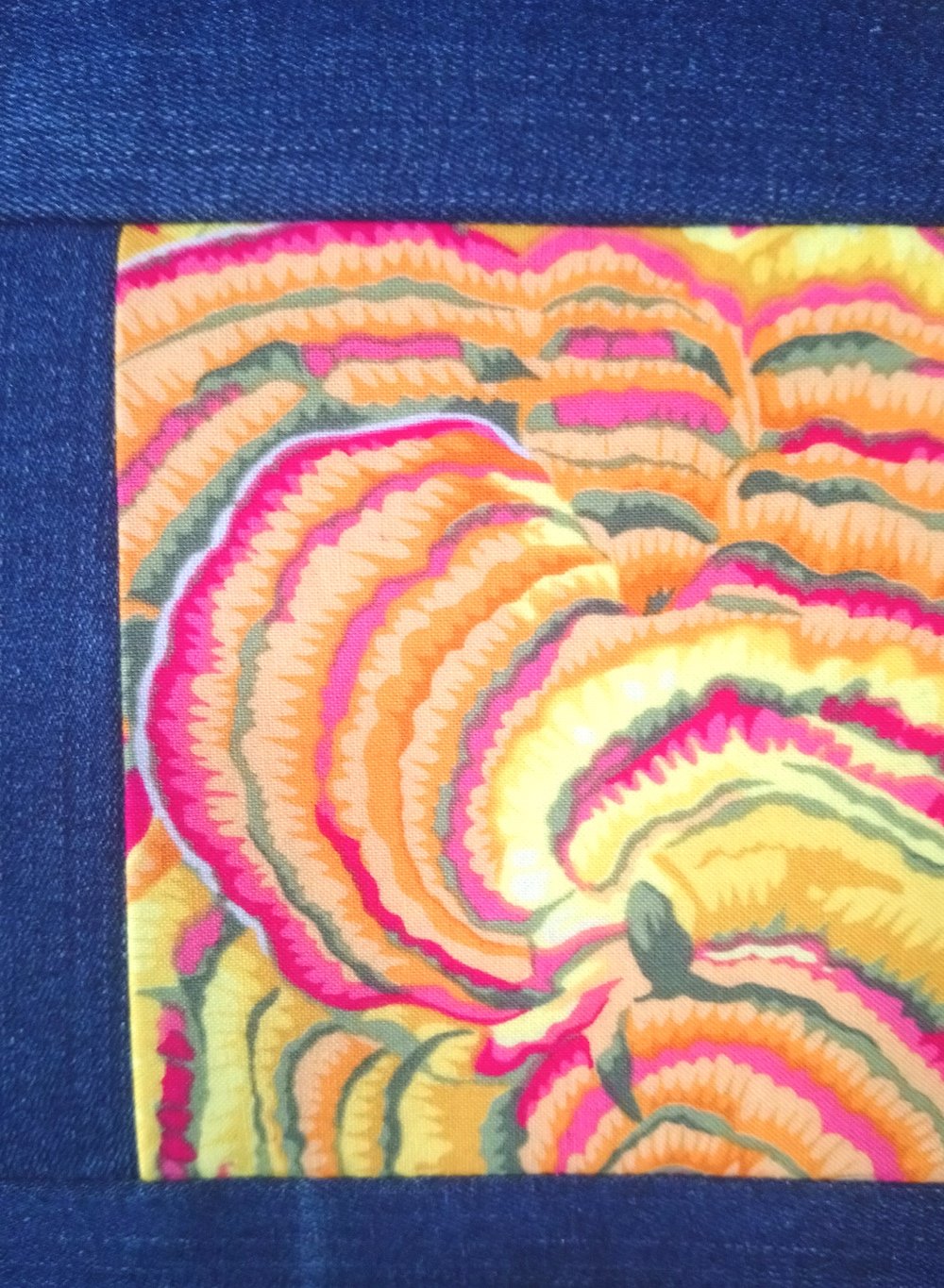 Close up of denim patchwork and print.JPG