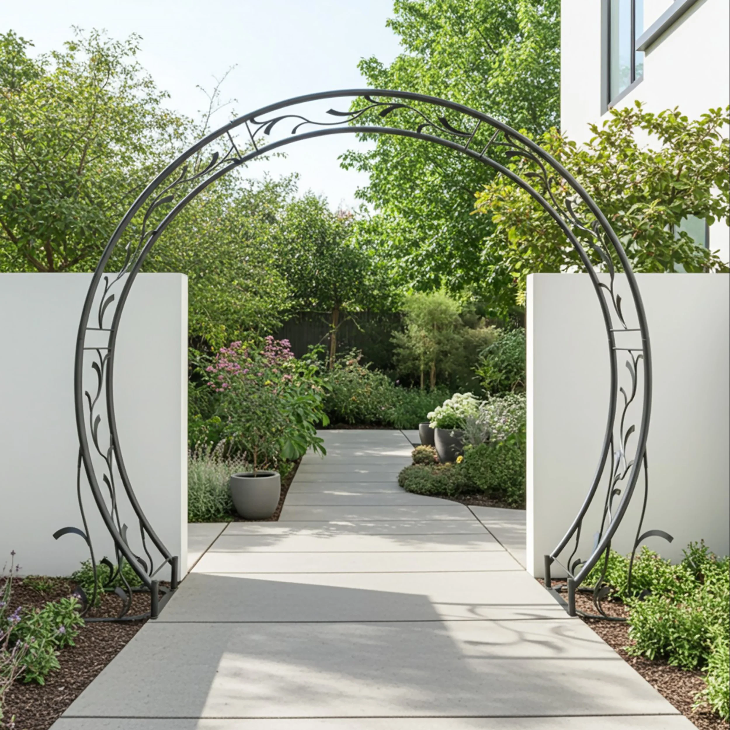 A garden path with potted plants and lush greenery viewed through a decorative metal archway.