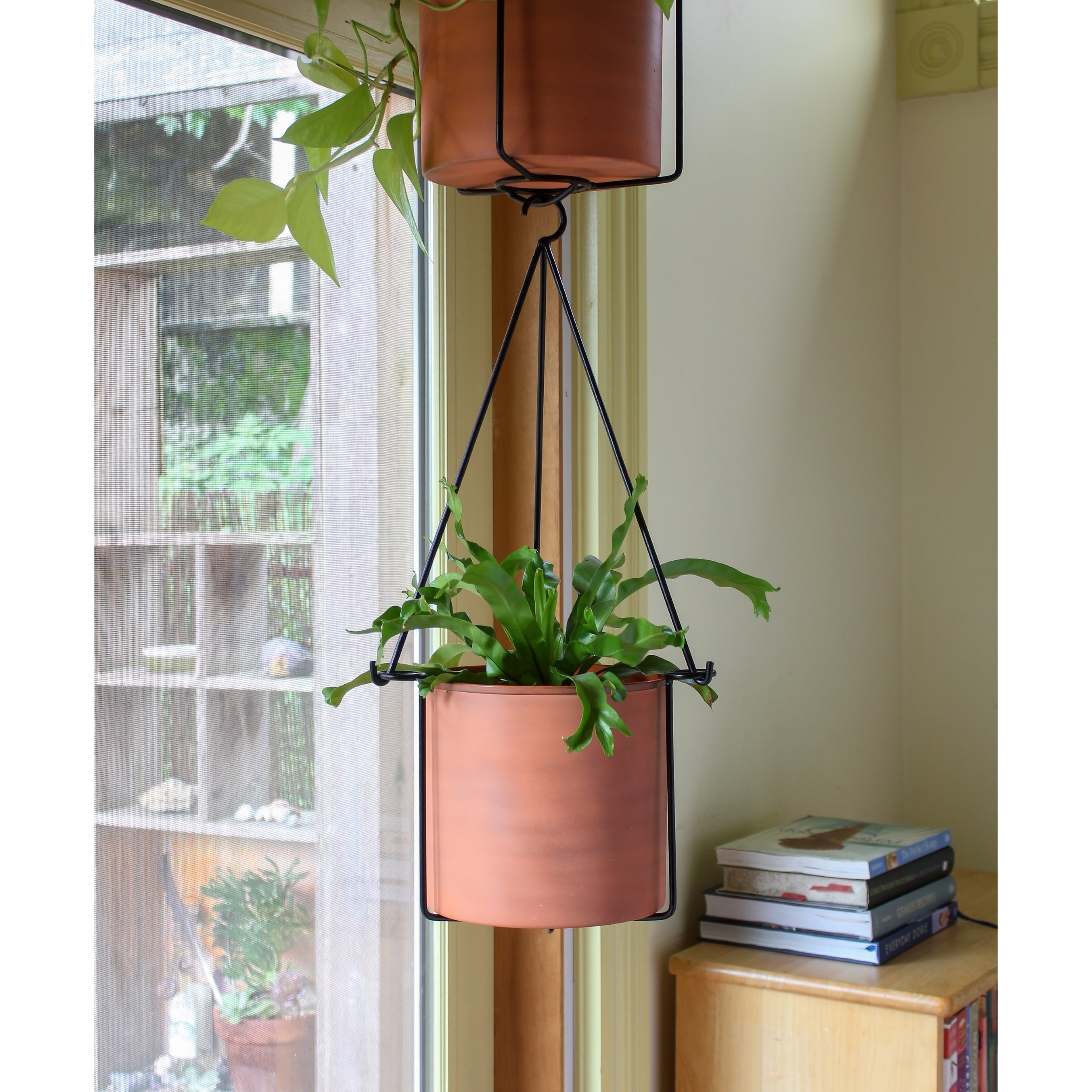 Two, Wrought Iron, Black powder coated contemporary hanging planters that connect at the base.