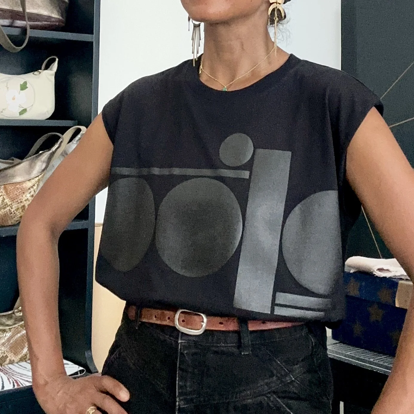 A woman wearing a black geometric graphic sleeveless tank
