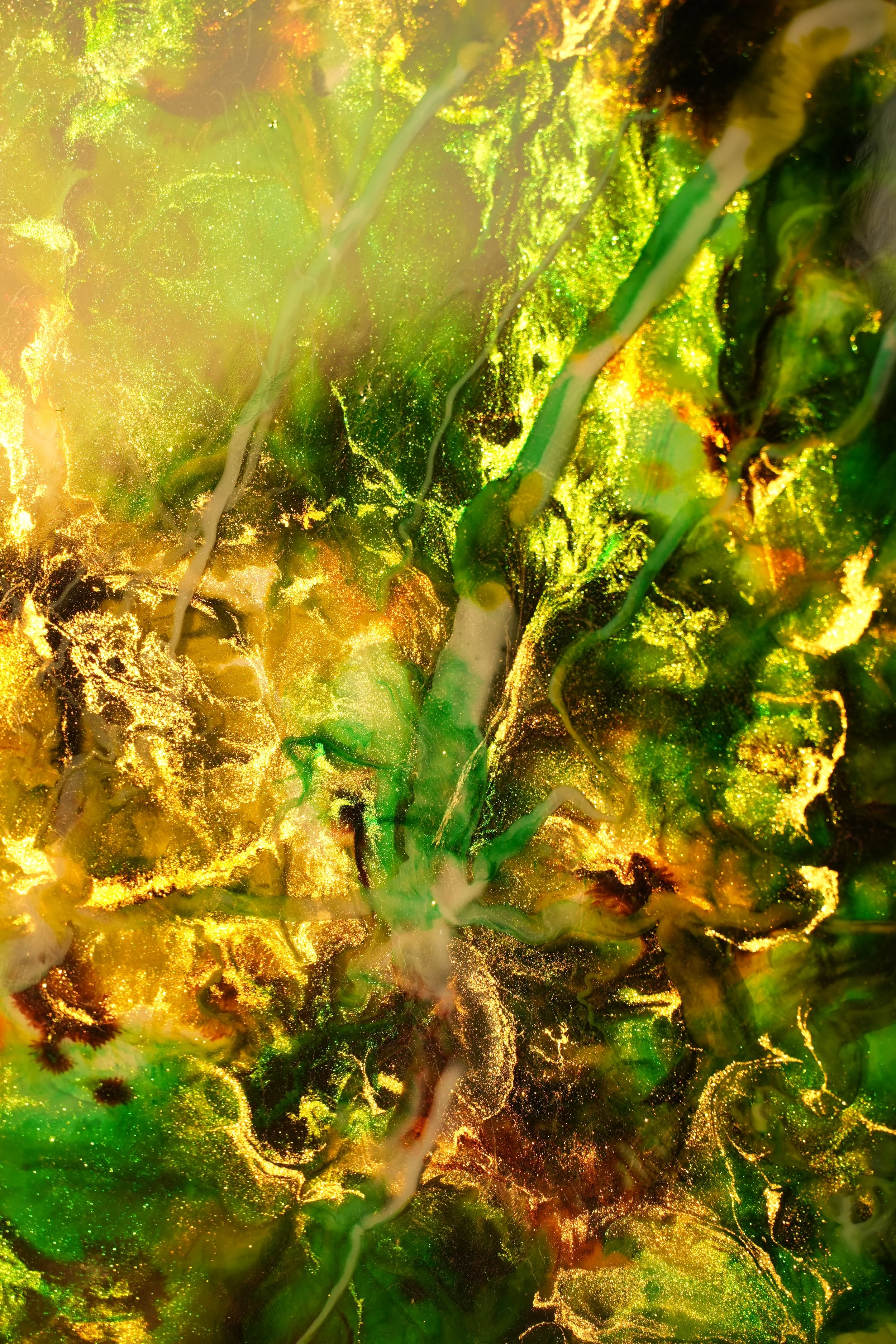 Abstrato com cores vibrantes de dourado, verde, amarelo e preto, com detalhes brilhantes e formas fluidas que lembram padrões orgânicos ou de pigmentos em movimento.
