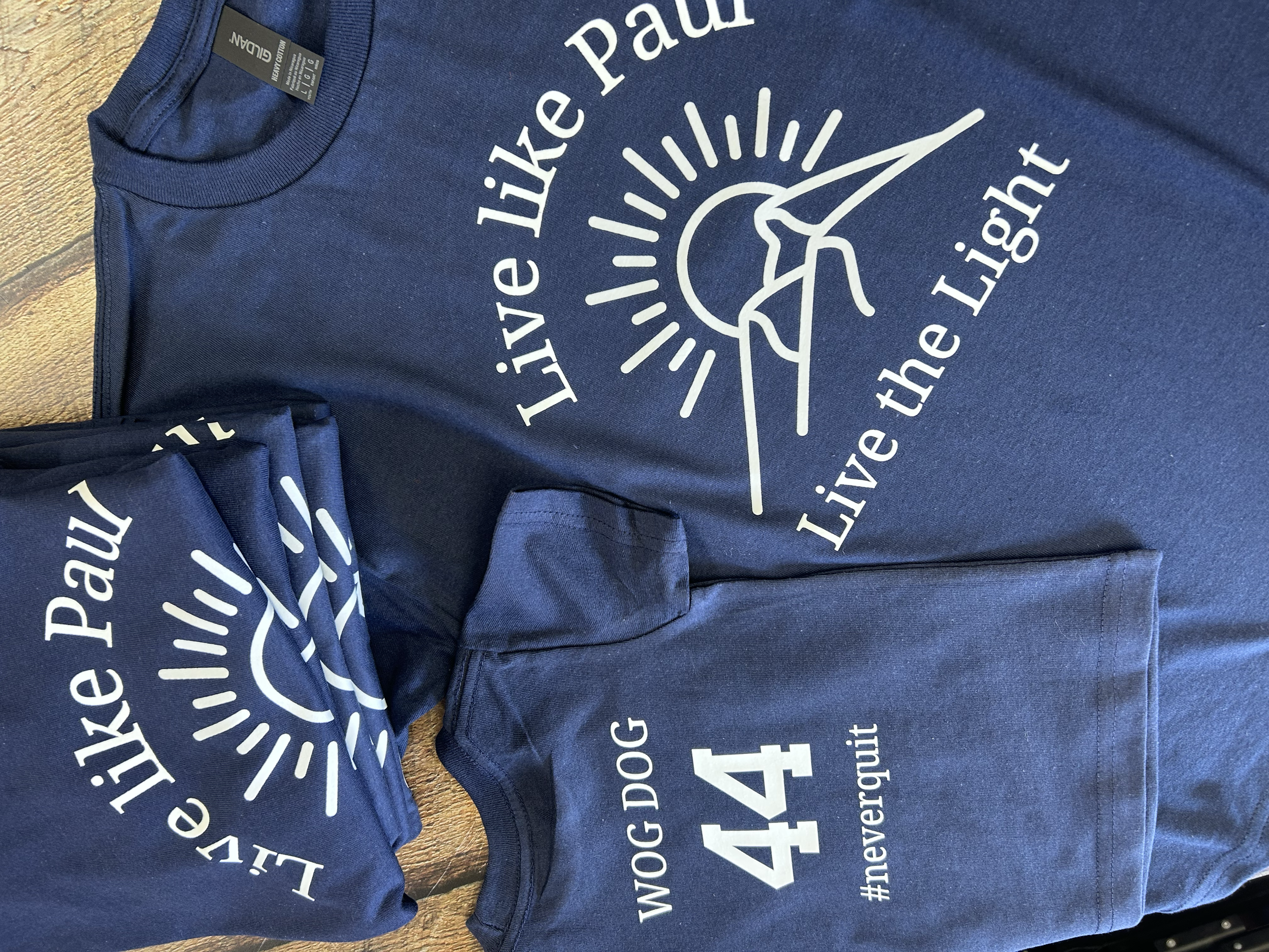 Custom order of t-shirts with the text Live Like Paul, Live the Light.