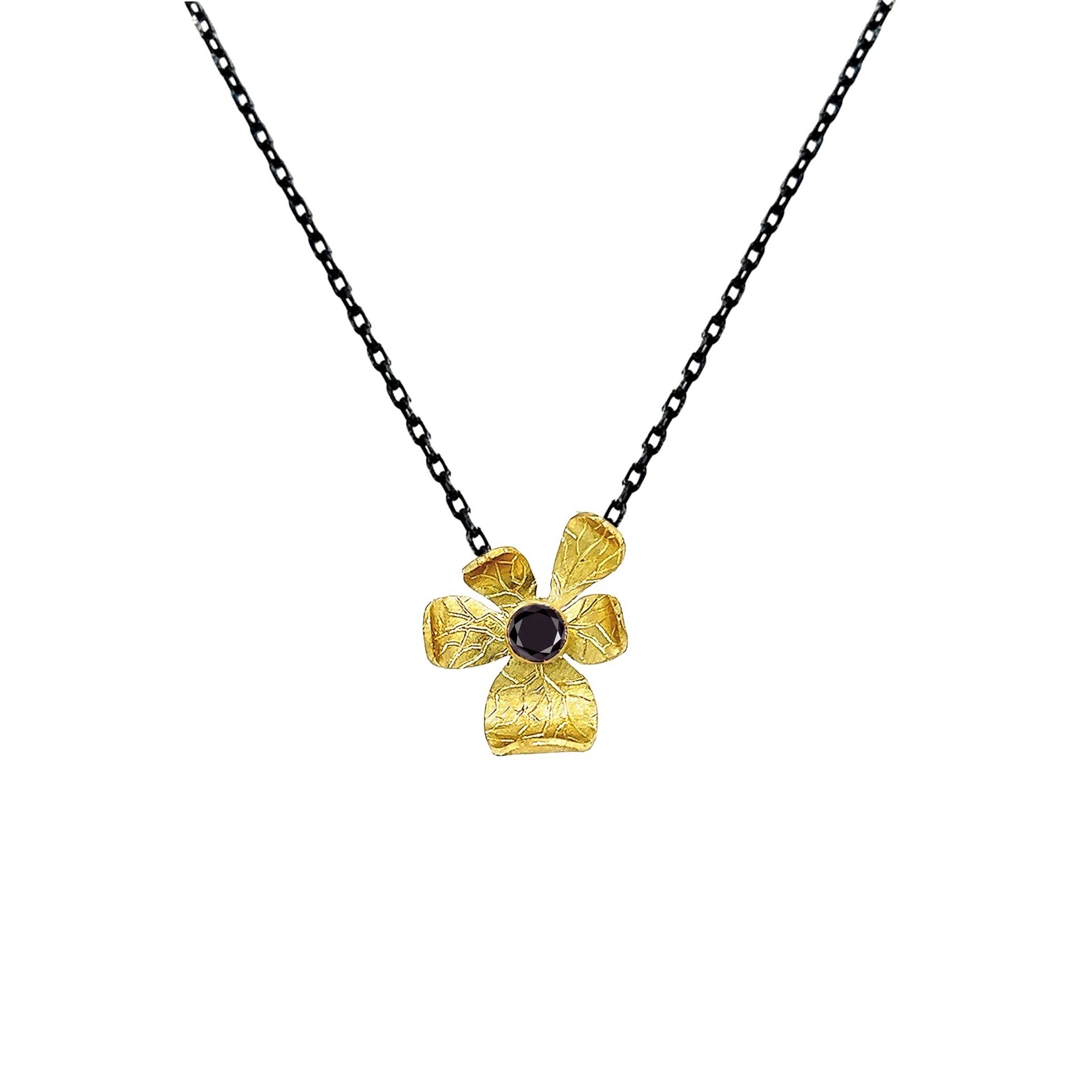 hand-fabricated 18K reclaimed gold floral pendant with 2.5mm black diamond on oxidized silver chain