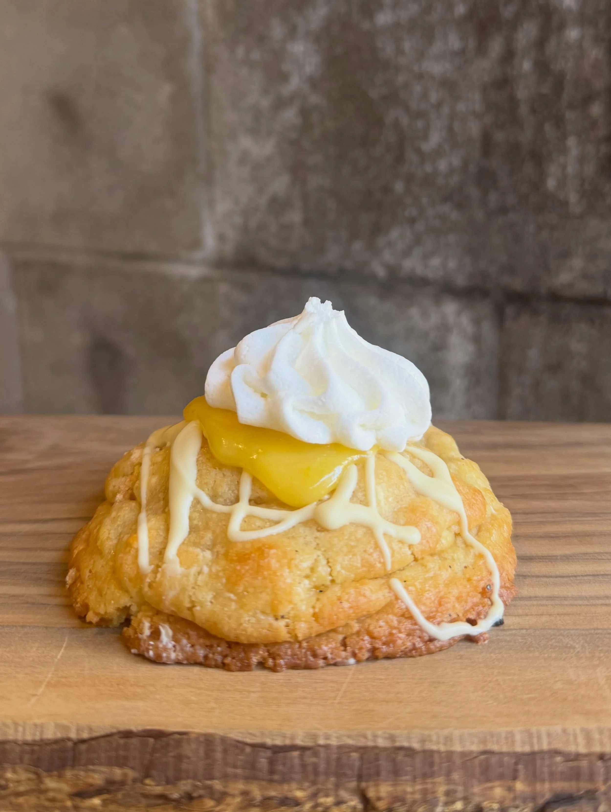 The lemon meringue NYC cookie

ooey gooey cookie studded with white chocolate, fresh lemon zest, and shards of meringue. Stuffed with our house made lemon curd and a meringue cloud on top. 
This one is fresh. 

Other NYC cookies in store:
-Nutella st