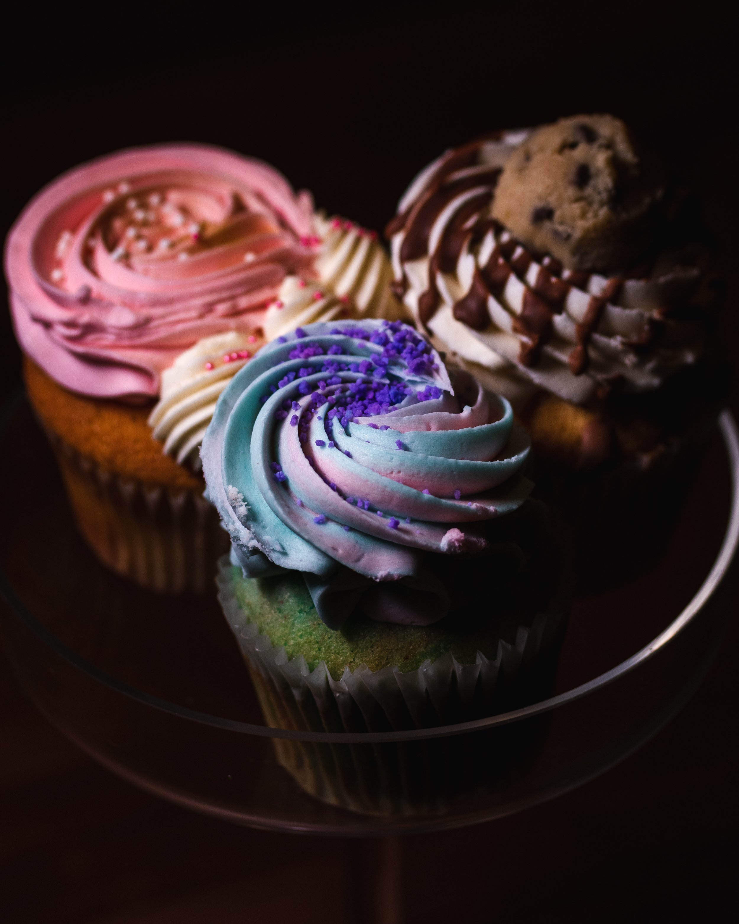 Strawberry Vanilla Cupcake (top left); Cookie Dough Cupcake (top right); Cotton Candy Cupcake (centre bottom)