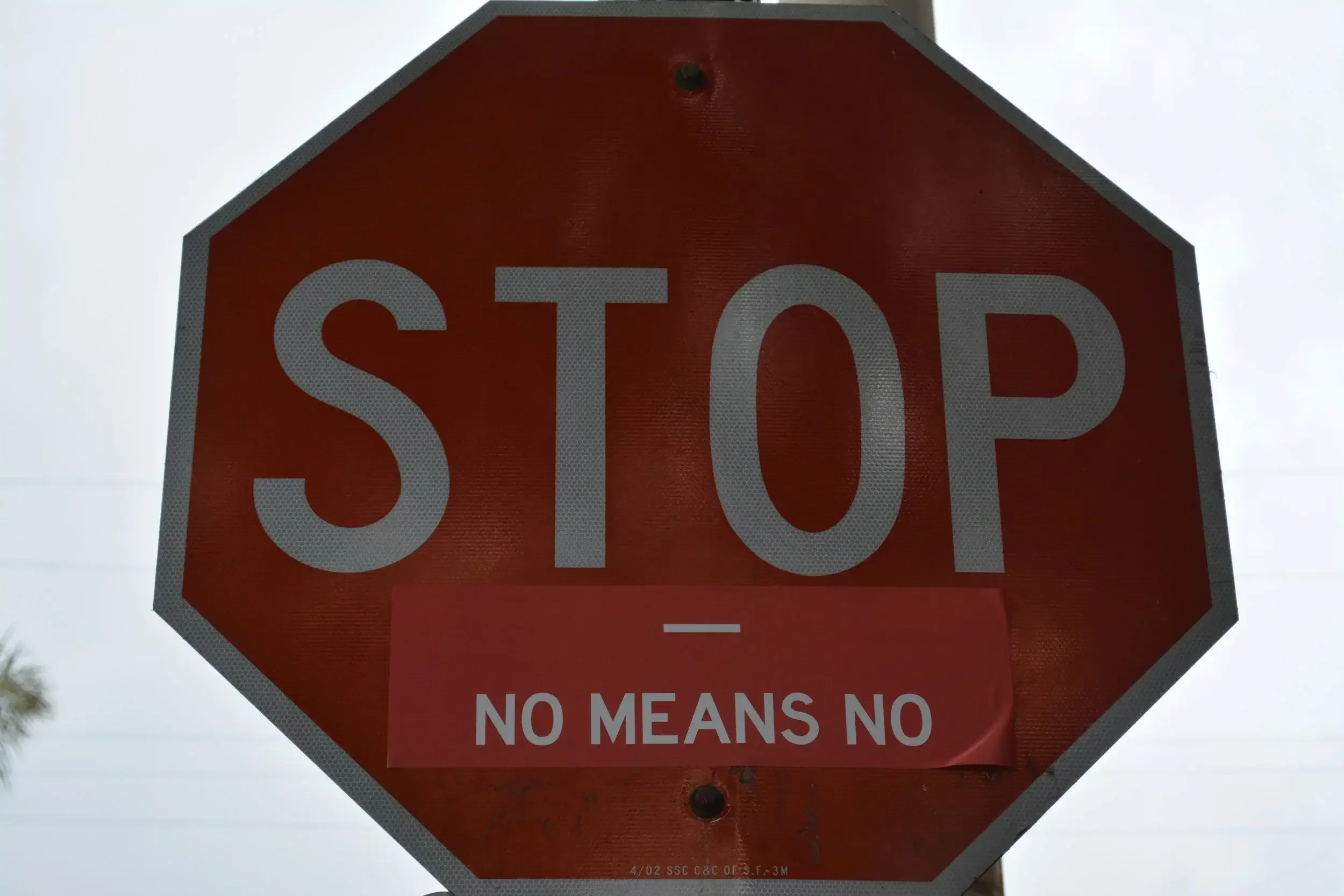 Photo of a stop sign with an addition of "no means no," representing sexual assault as an example of trauma. Online trauma therapy in California can help you recover. | 90266 | 90277 | 90274