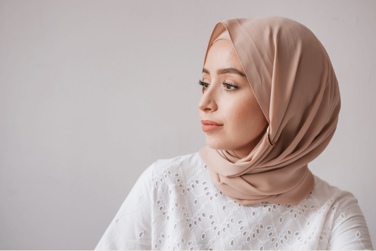 A woman with a headscarf looking away representing the anxiety that comes from experiencing trauma from sexual assault. Therapy with a woman therapy in South Bay can help with trauma and PTSD. 90027 | 90266 | 90015