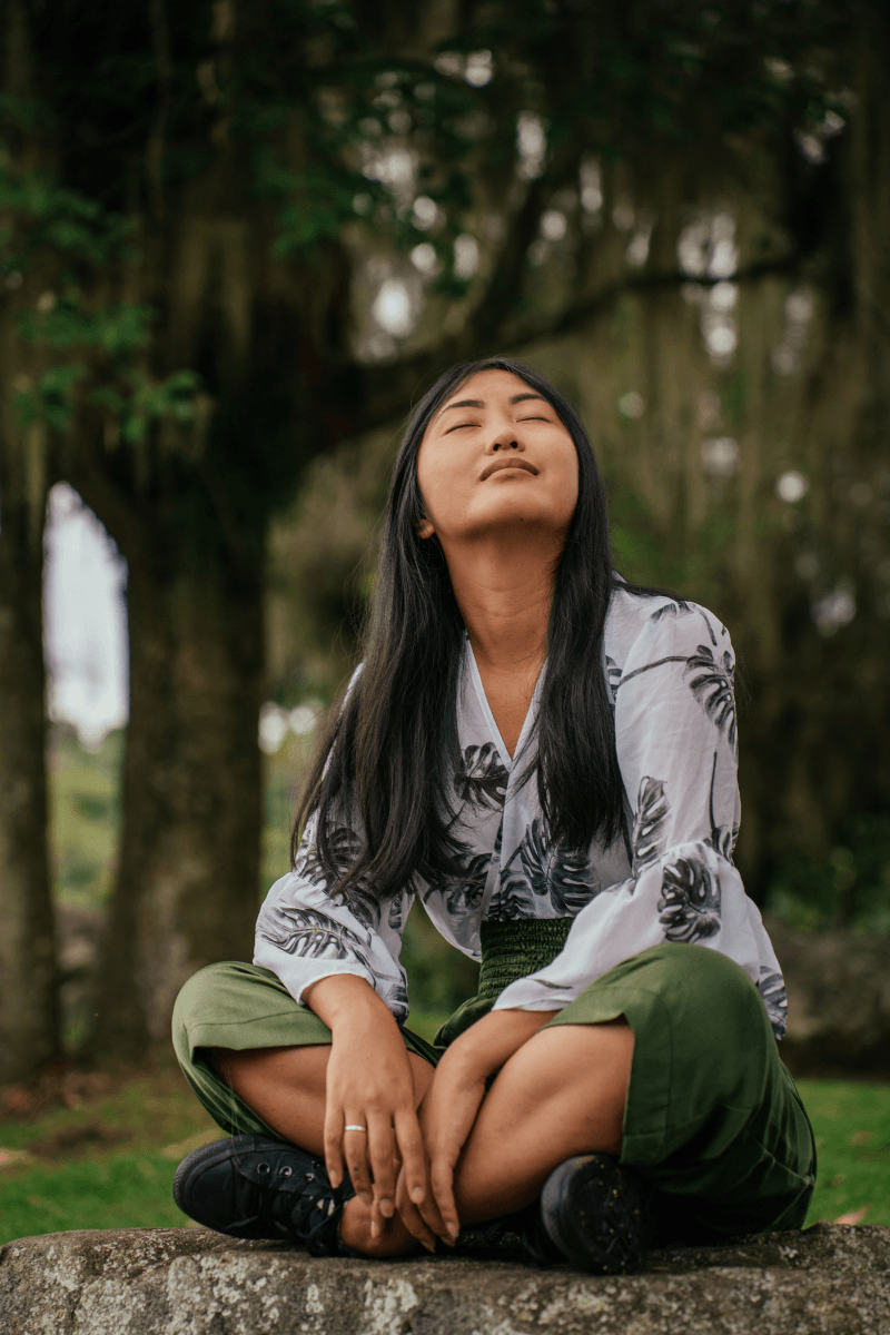 Woman in nature relaxing as a way to decompress. If you'd like help with being avoidant therapy in LA is available. 90027 | 90277 | 90401