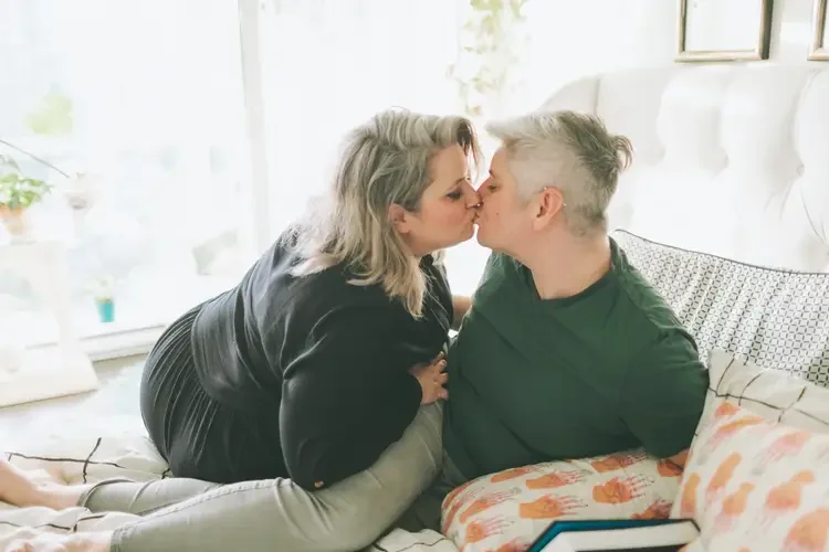 A white lesbian queer couple kissing, representing supportive sex therapy - addressing intimacy, desire, and sexual concerns. 90402 | 90277 | 90266